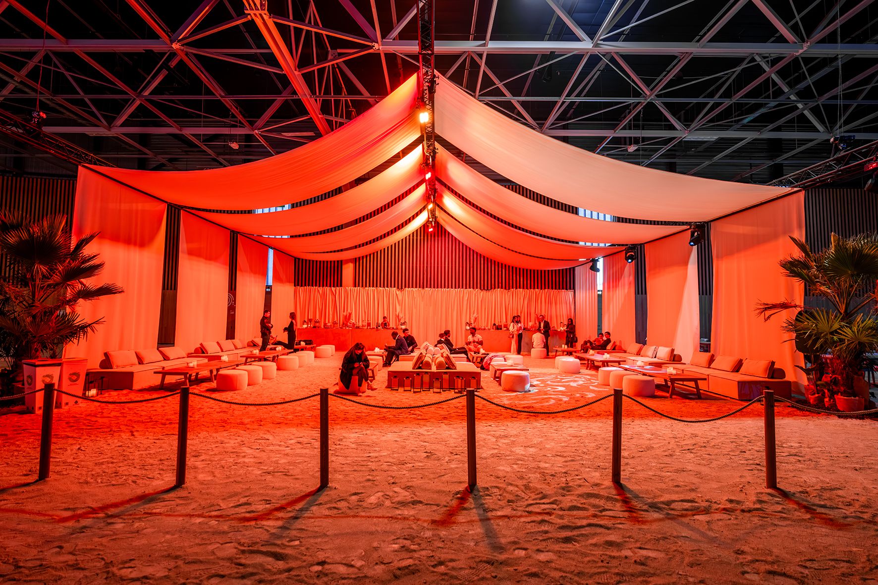 Modern orange lounge chair beside white coffee table.