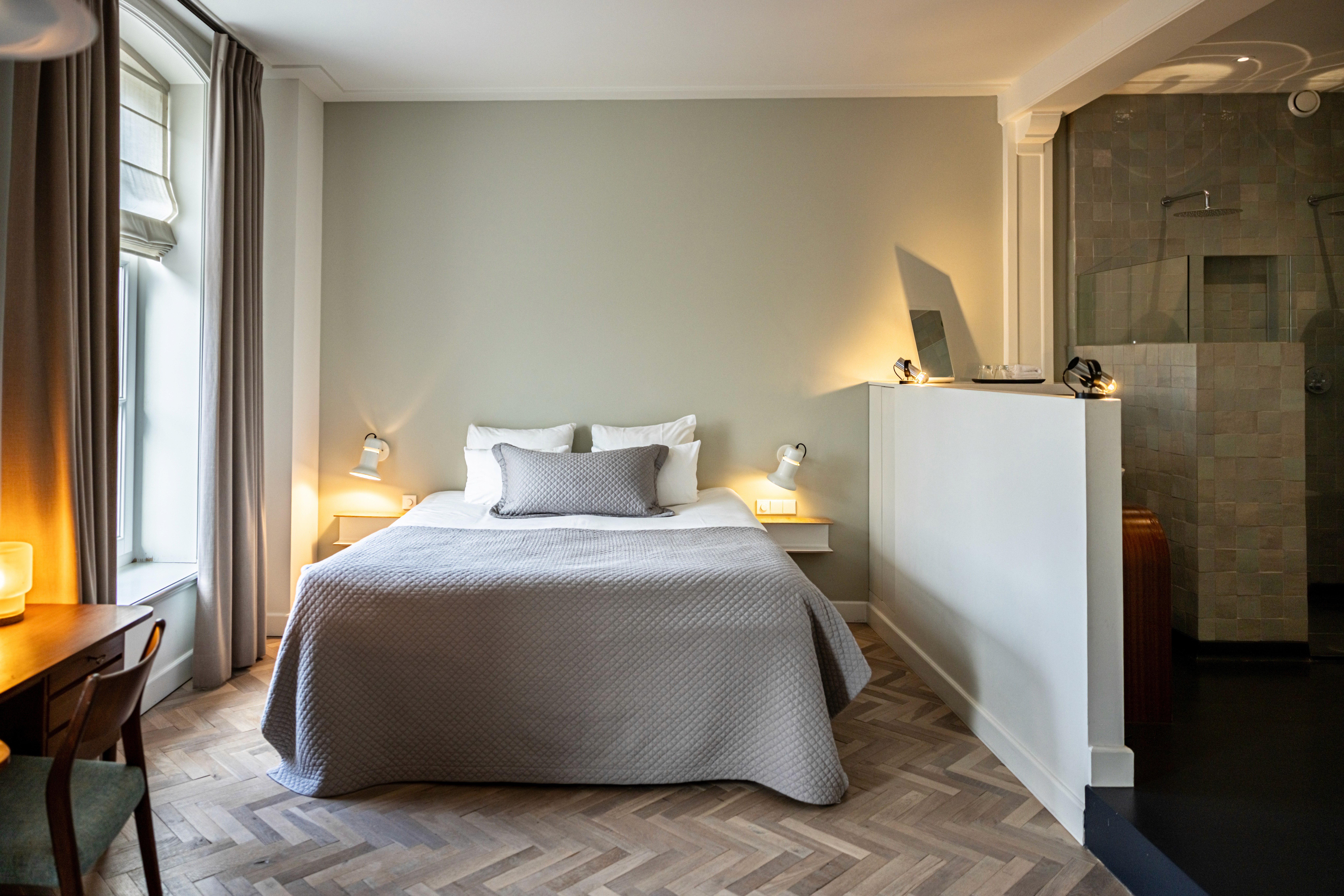 Sage green walls bedroom with lilac duvet and modern style