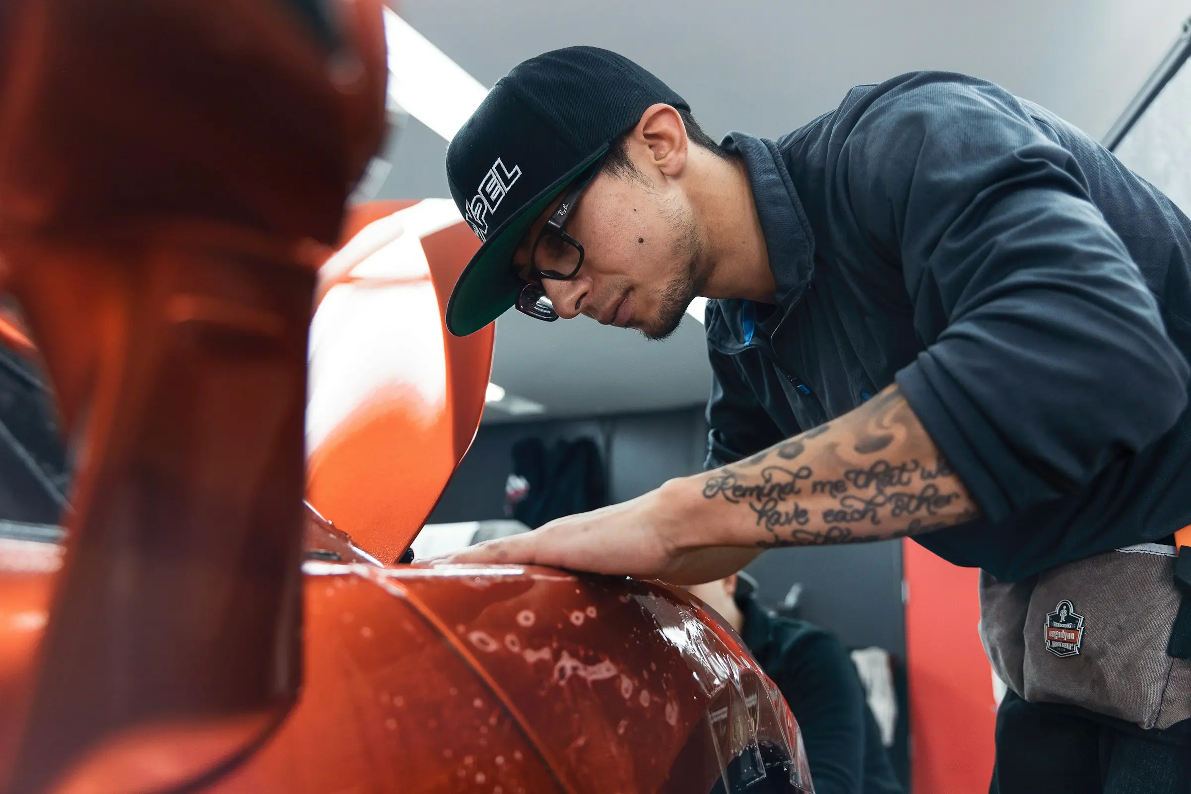 Car repair website design article cover showing an auto mechanic working on a vehicle to illustrate service-focused website design