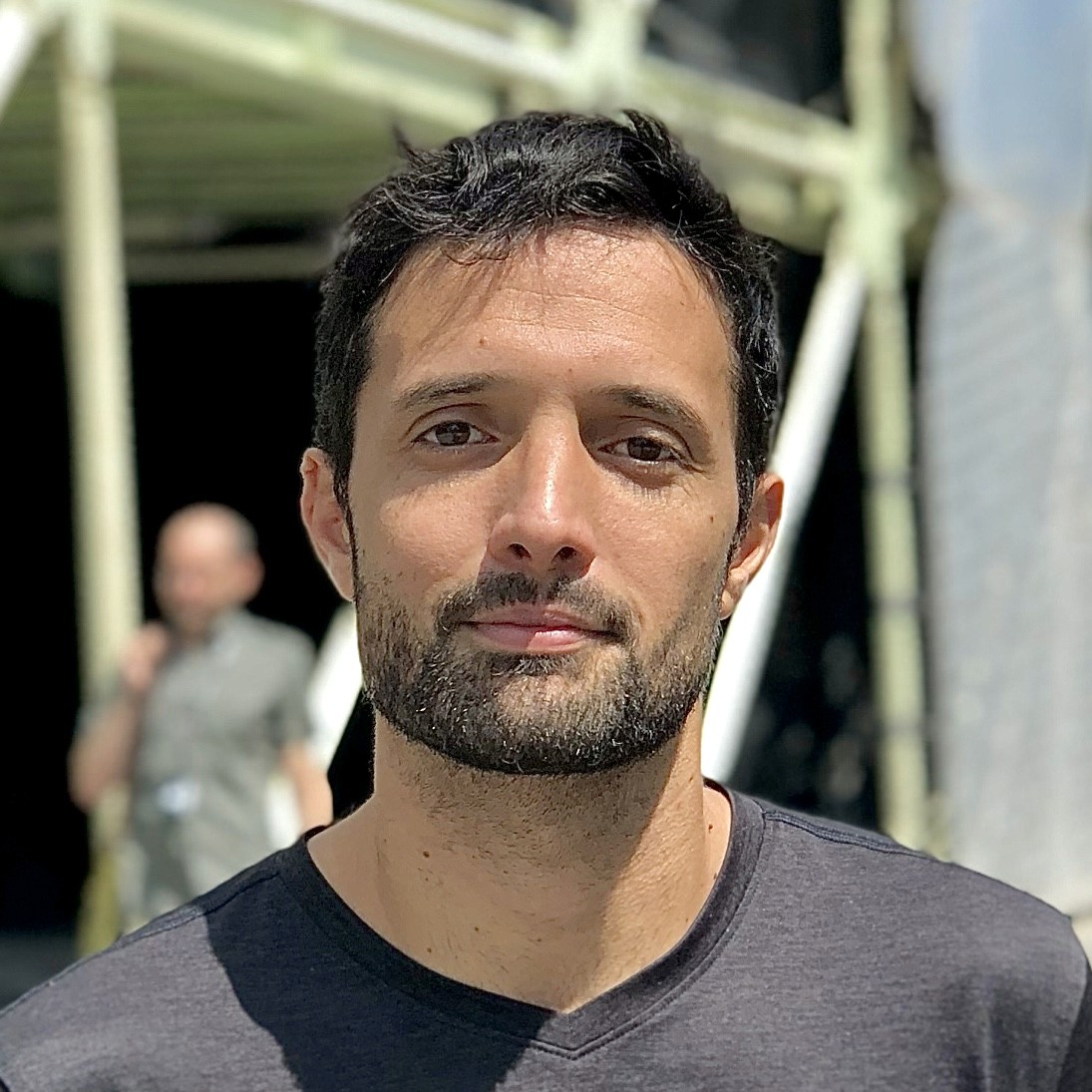 a man in a suit and glasses posing for a picture