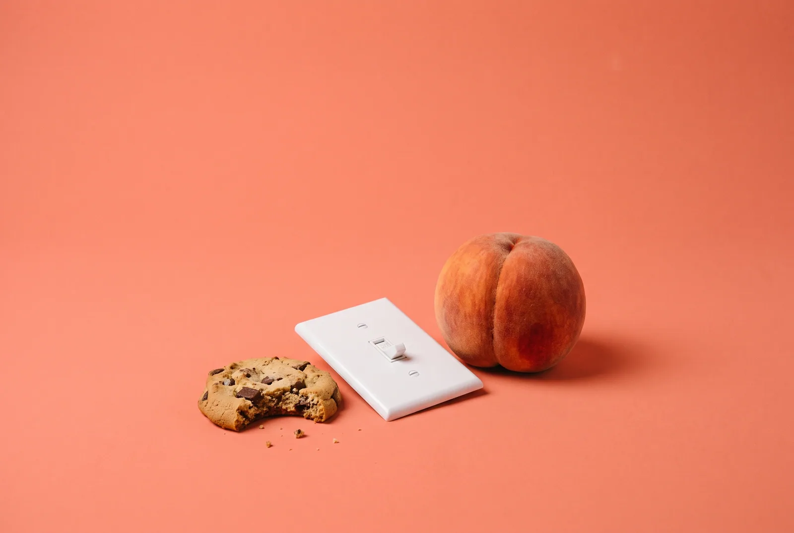 A half-eaten cookie beside a switch flipped off and a peach, why SafeSearch keeps turning off and how to lock SafeSearch