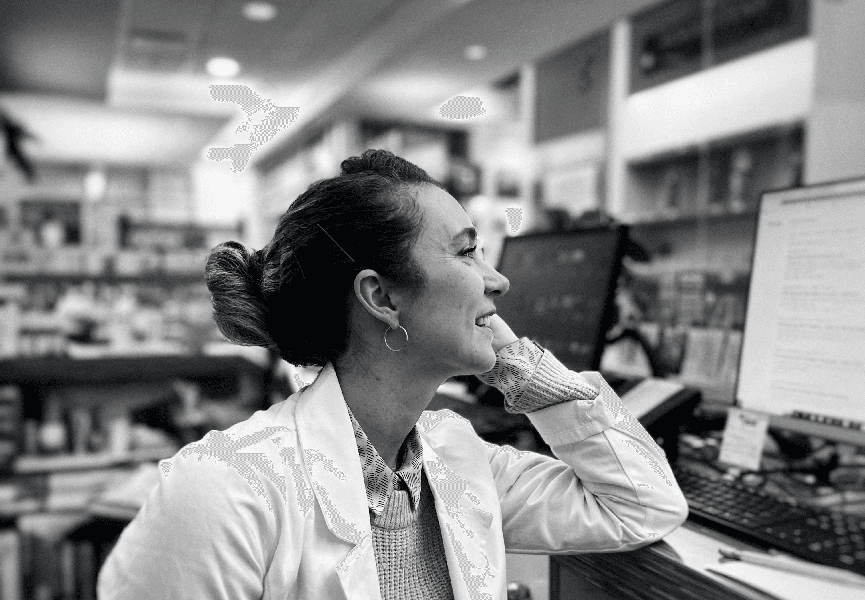 Pharmaceutical professional reviewing digital tools in a clinical workspace