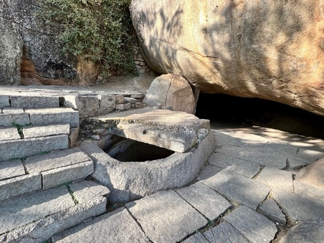 The oil cauldron carved in rock and half covered