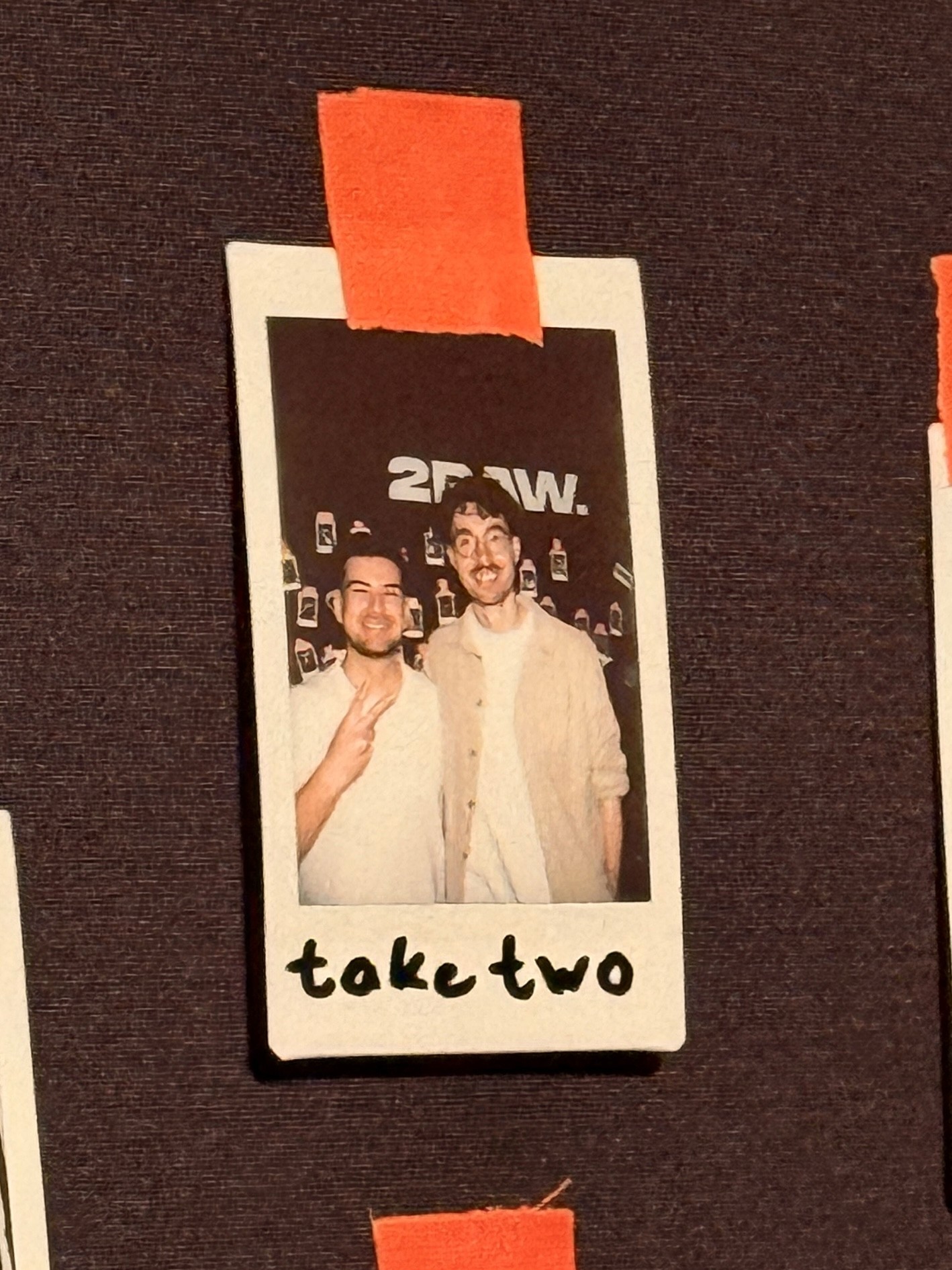 Group of friends smiling on a lively city street at night