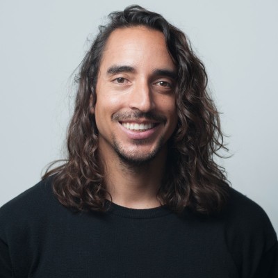 Black and white portrait of a smiling person with curly hair