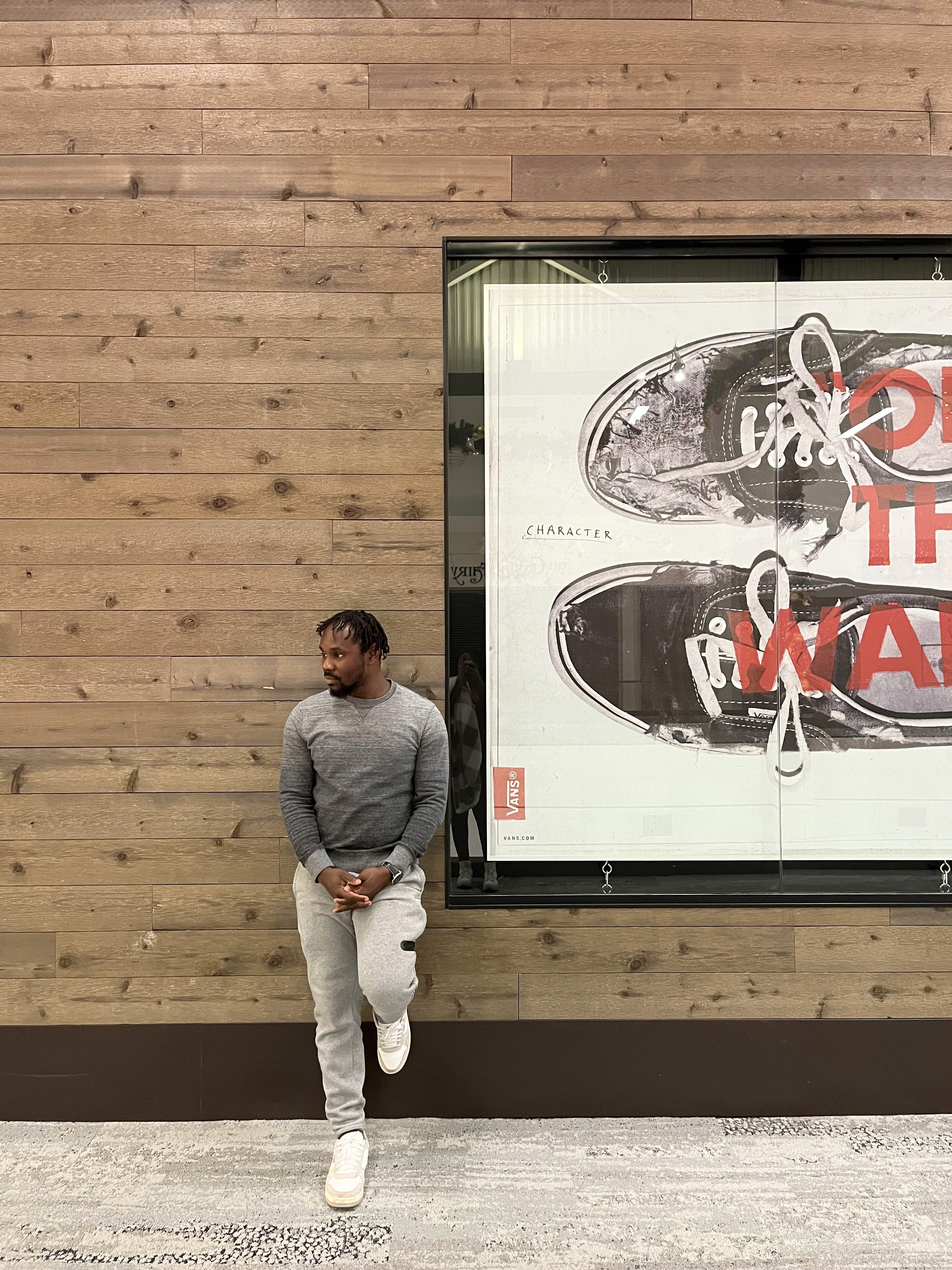 Peace Badejo, wearing sunglasses, looking to the left.