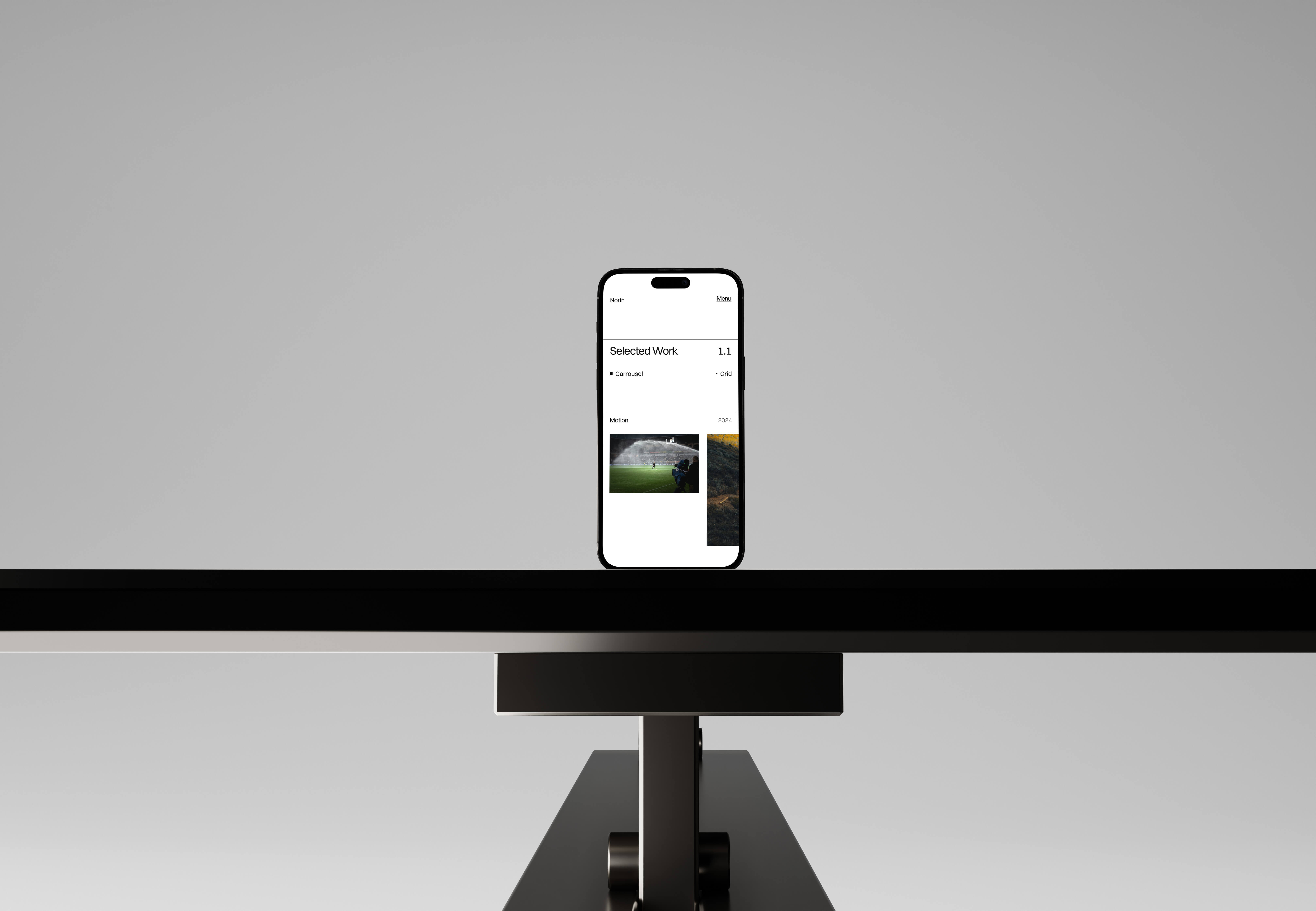 Norin website work pages displayed on an iphone in a studio setting