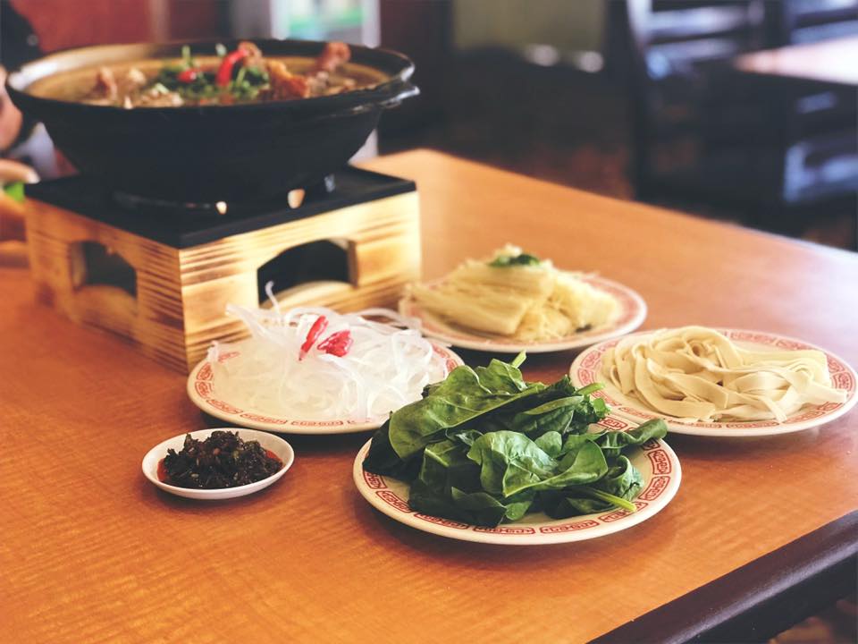 A bountiful table spread featuring sesame bread, lamb soup, hand-pulled noodles, and classic American-Chinese favorites, celebrating the diverse menu at China Islamic Restaurant.