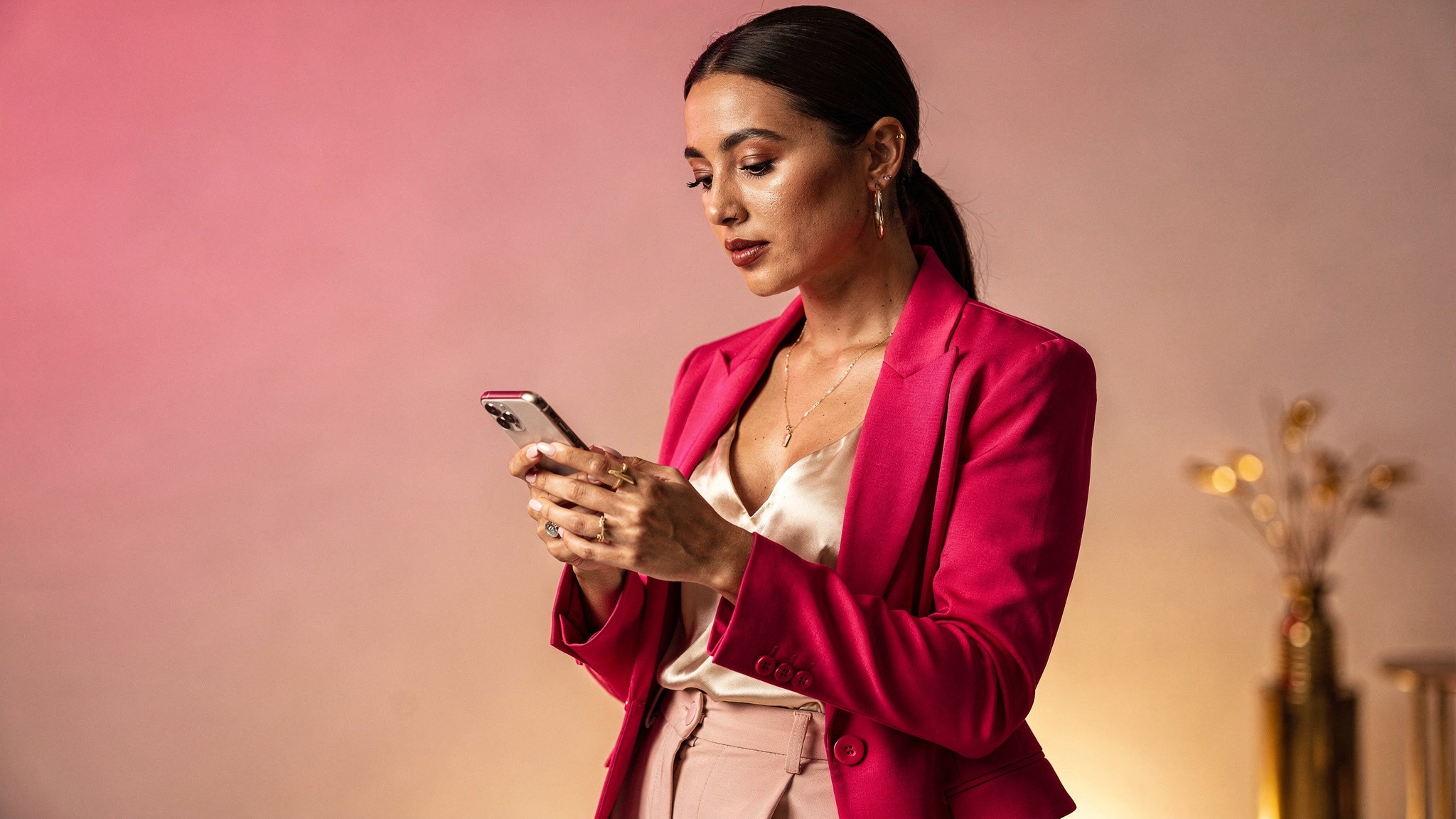 Creator typing a caption on her phone with a focused expression