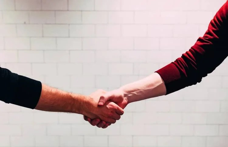 two people doing a handshake