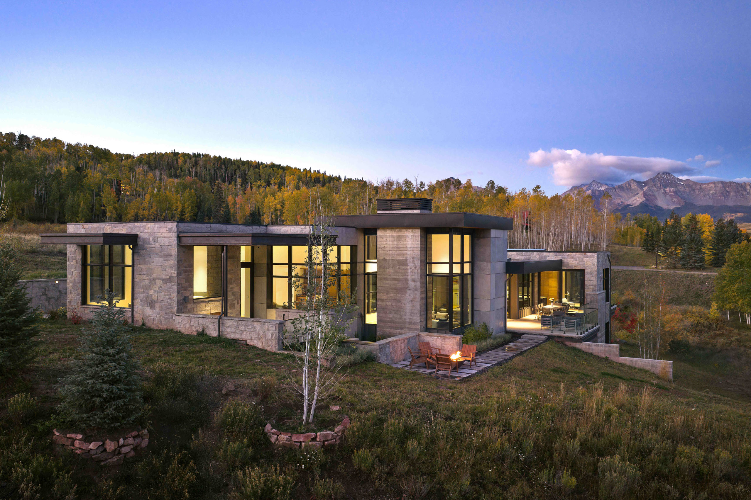 Modern house on a hill with mountain backdrop