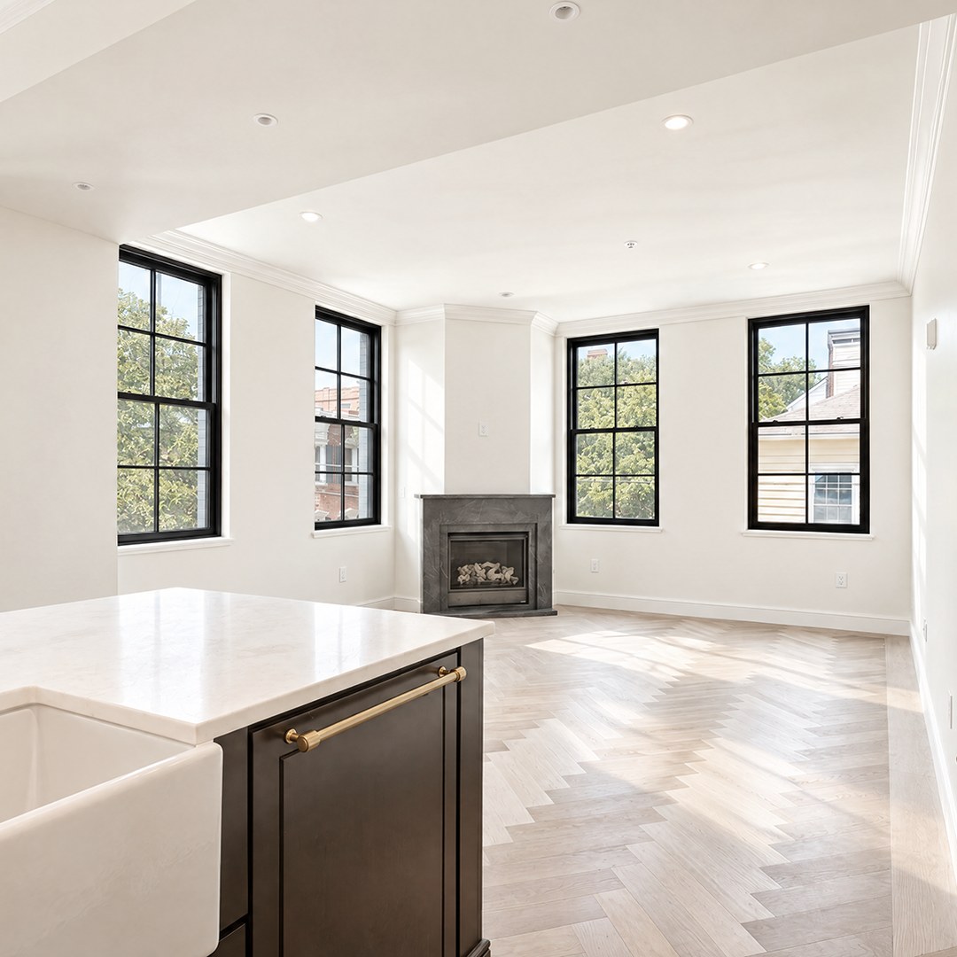 Living room with corner fireplace beyond the island