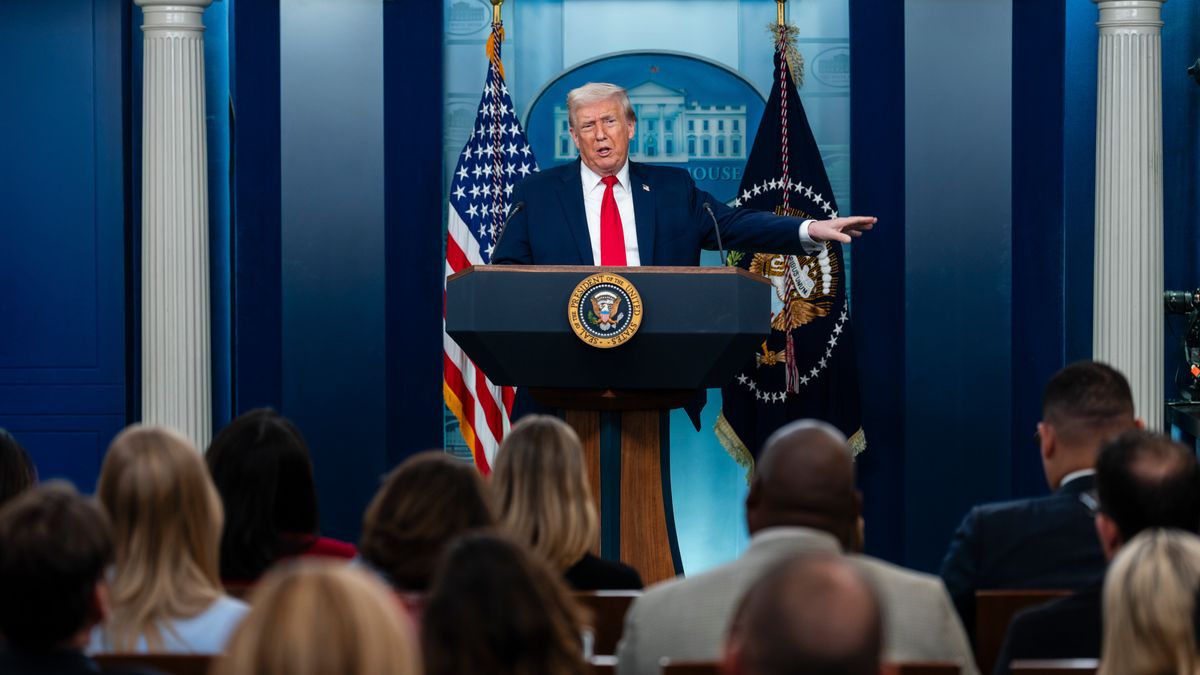 a laptop computer sitting on top of a white chair