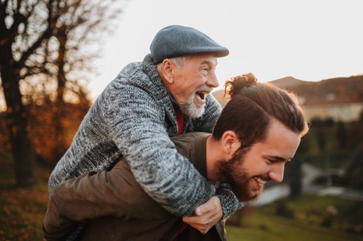 A maroon passport, a credit card, and a document are placed on a dark surface.