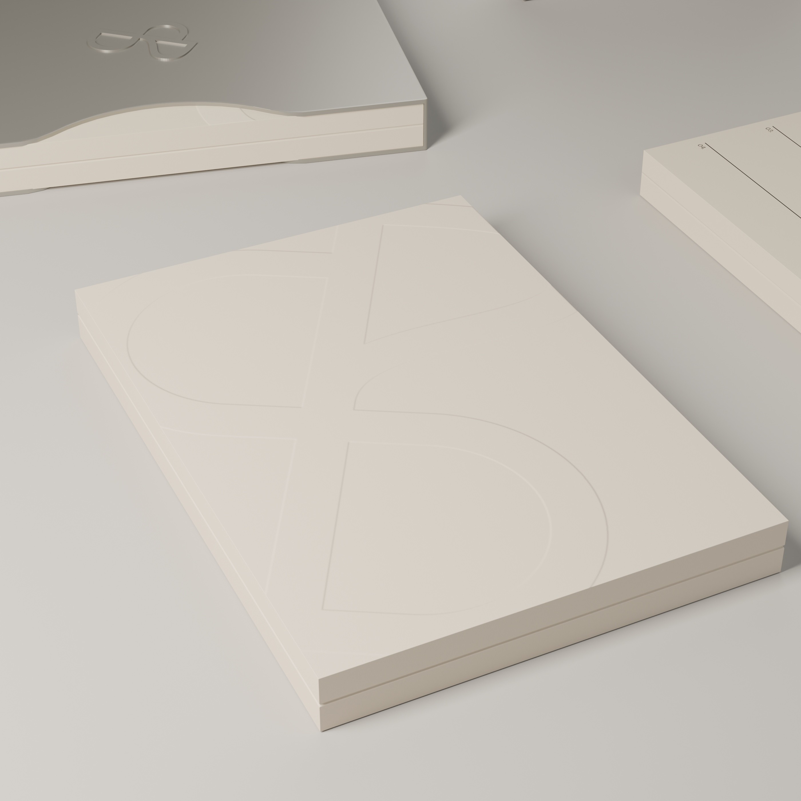 Close view of the large Sjöman Partners monogram blind-embossed into warm ivory paper, with no contrasting ink