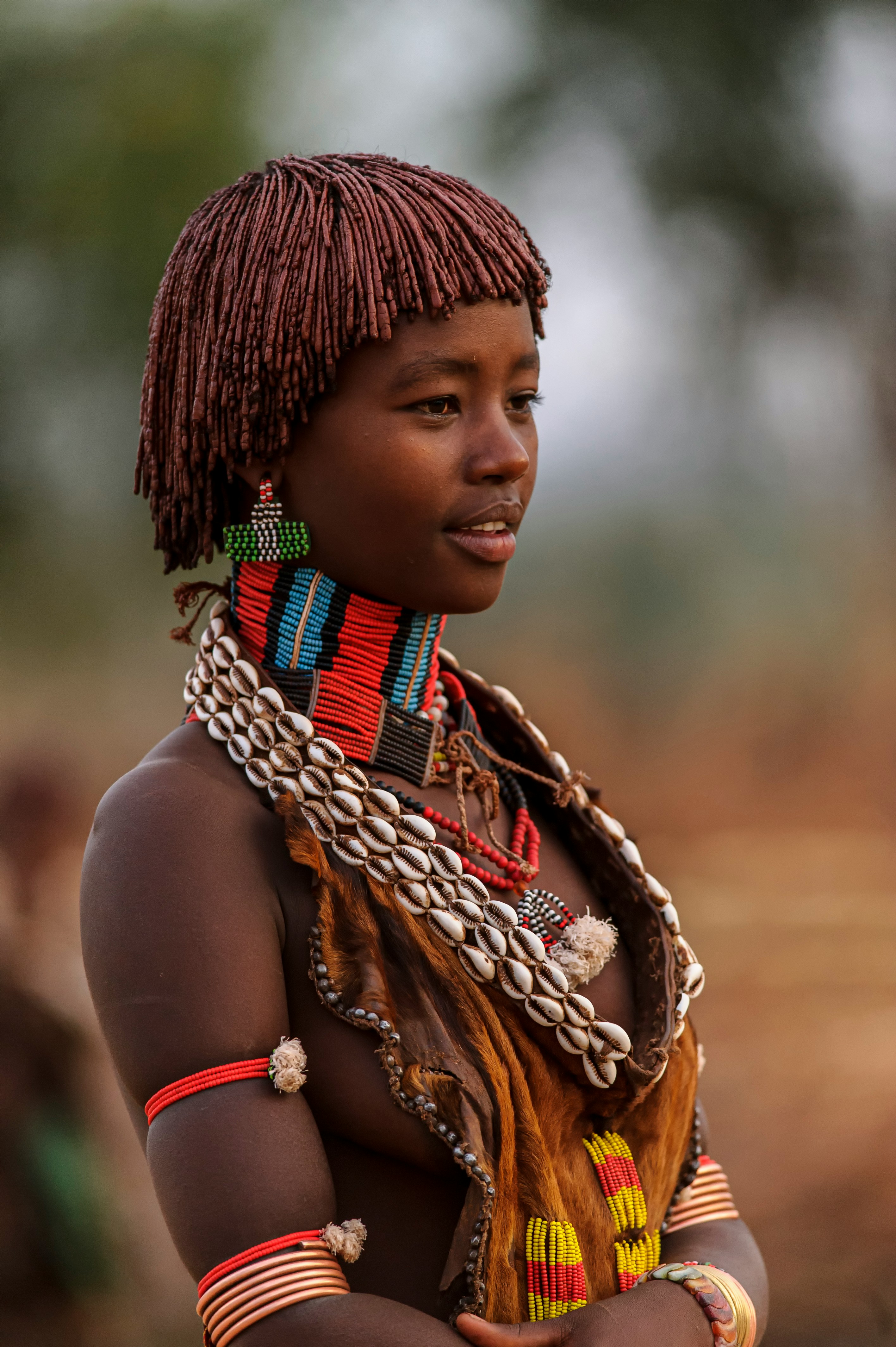 a woman adorned with a necklace and headdress