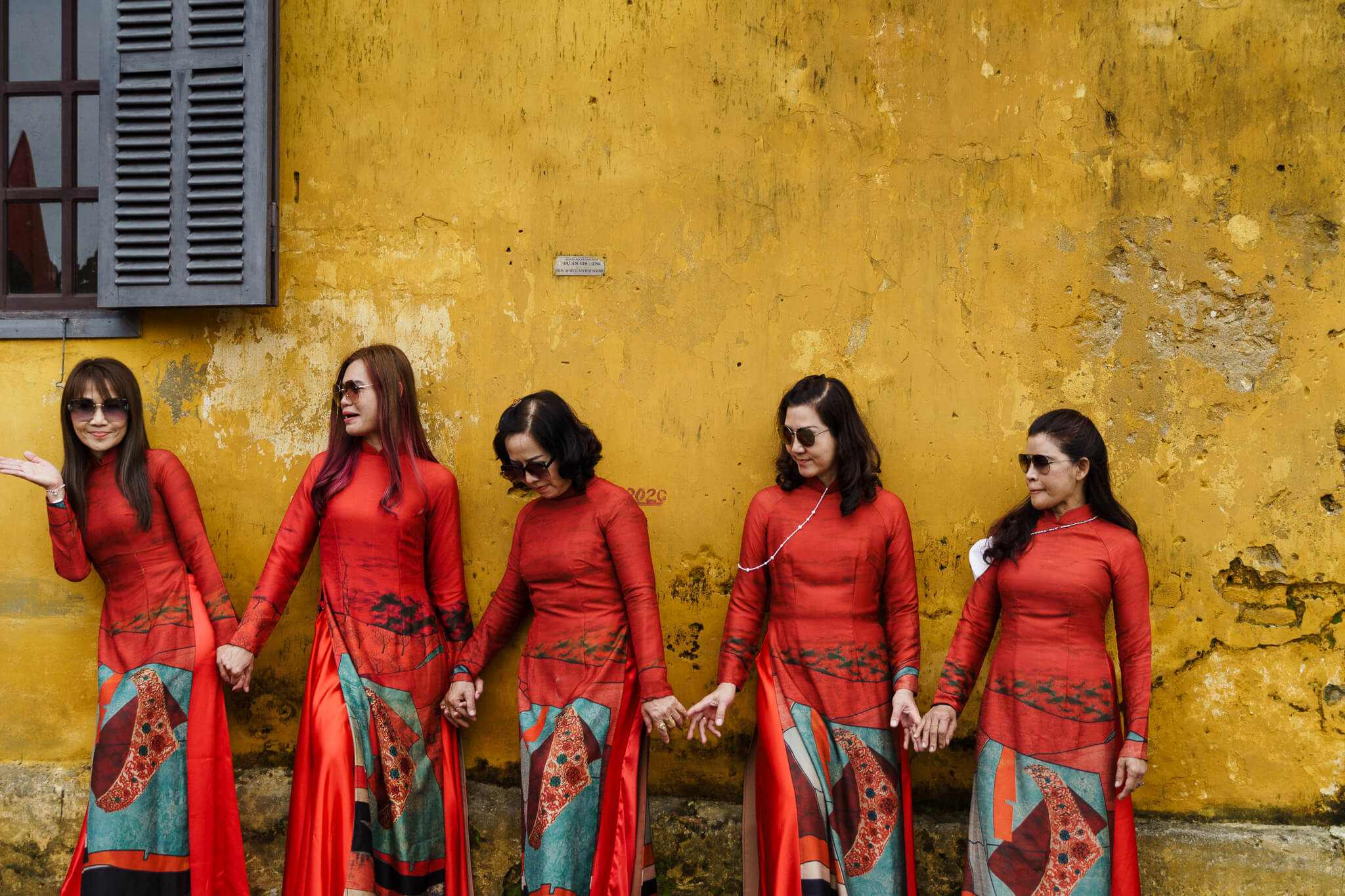 Women posing with red dresses