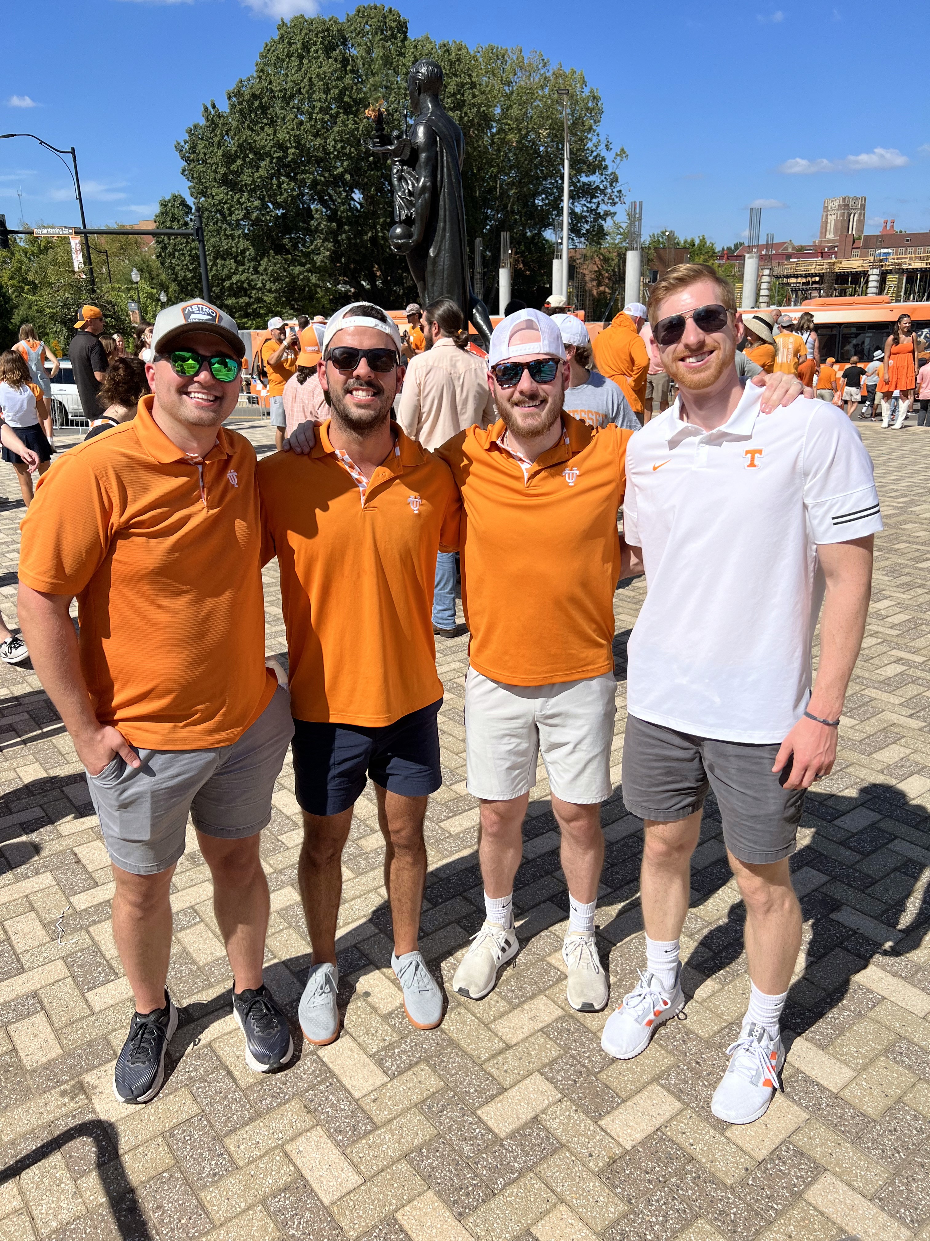 a group of people walking on a sidewalk