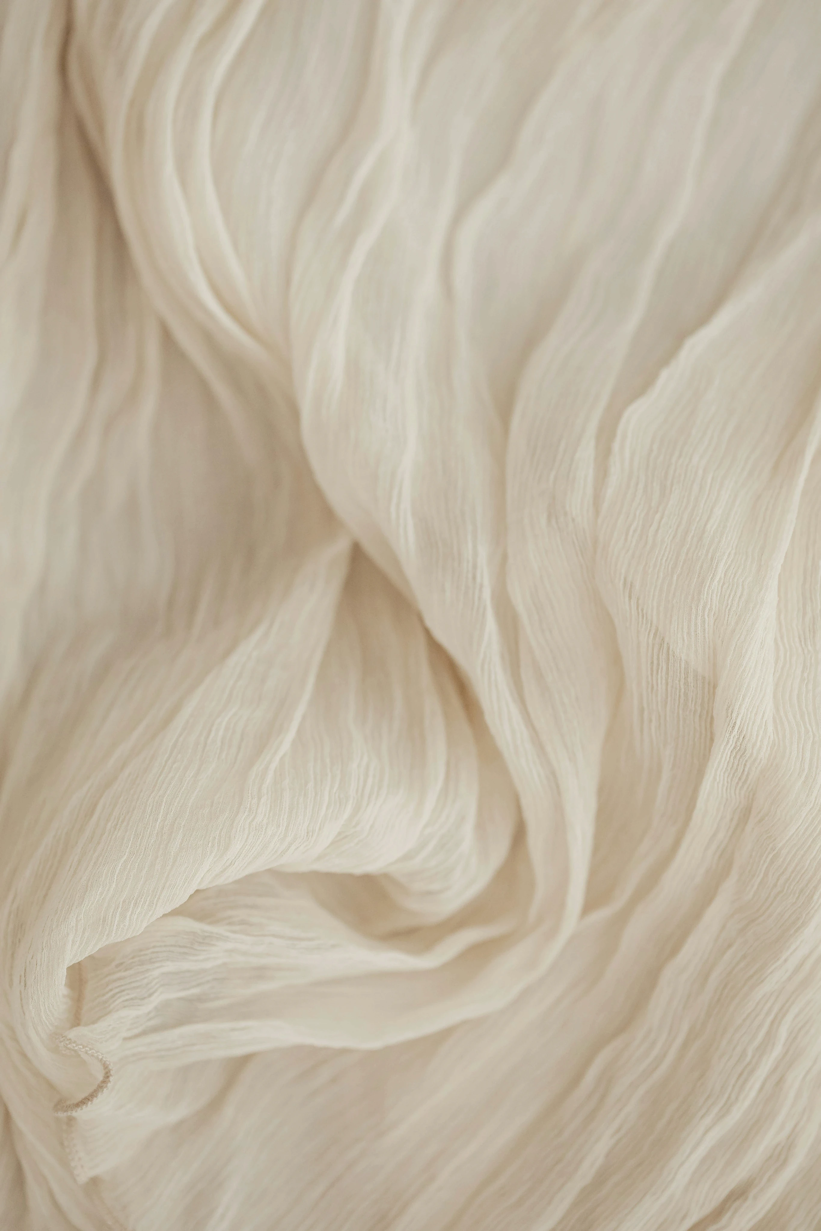 Minimalist ivory fabric background with soft natural lighting, reflecting a calm and sophisticated brand aesthetic.