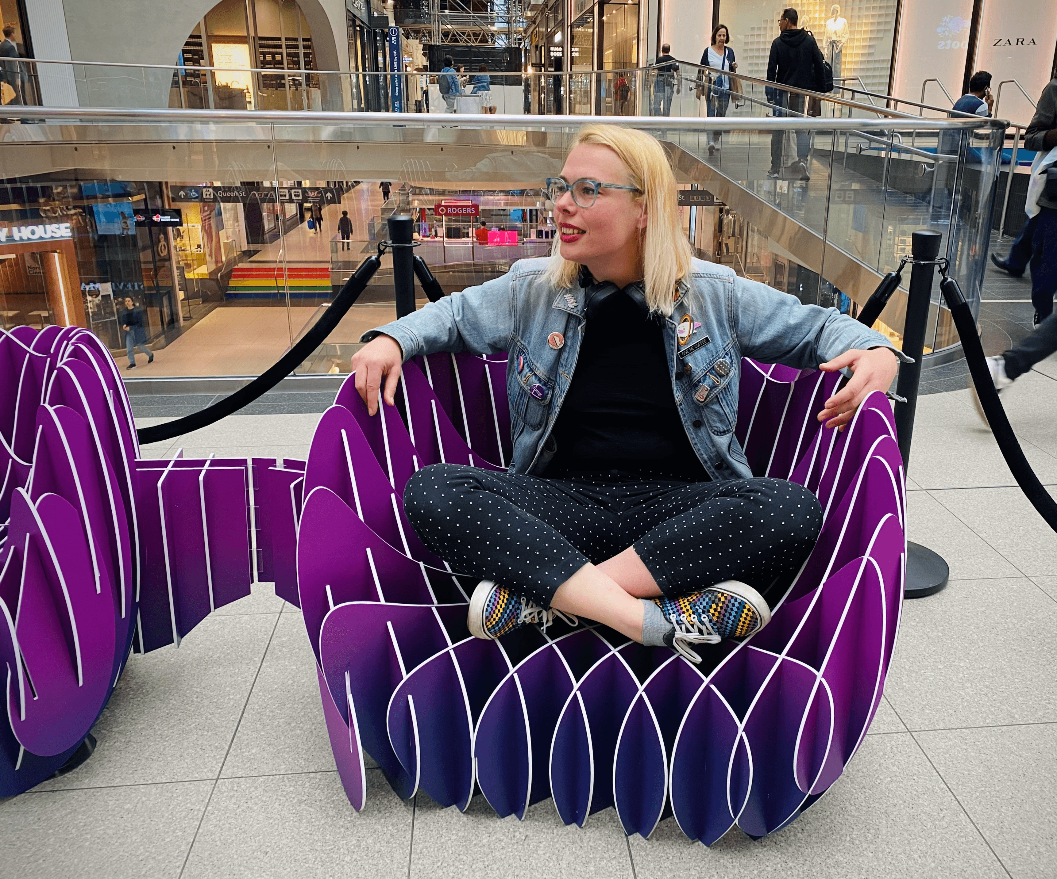 non binary person inside a public art instalation