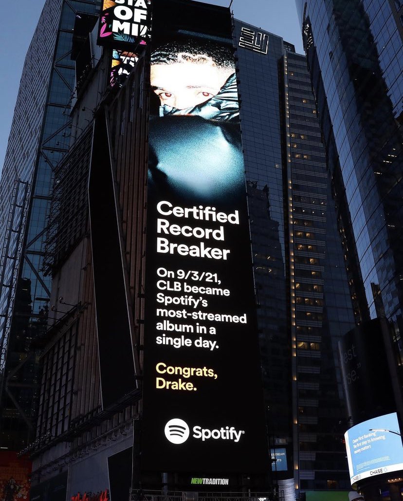 Times Square digital billboard showing Drake with the text: “Certified Record Breaker – On 9/3/21, CLB became Spotify’s most-streamed album in a single day. Congrats, Drake.”
