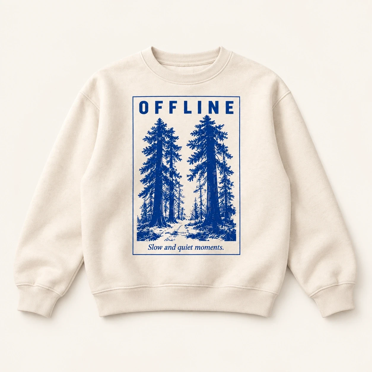 Cream crewneck sweatshirt with cobalt redwood illustration and Slow and quiet moments.