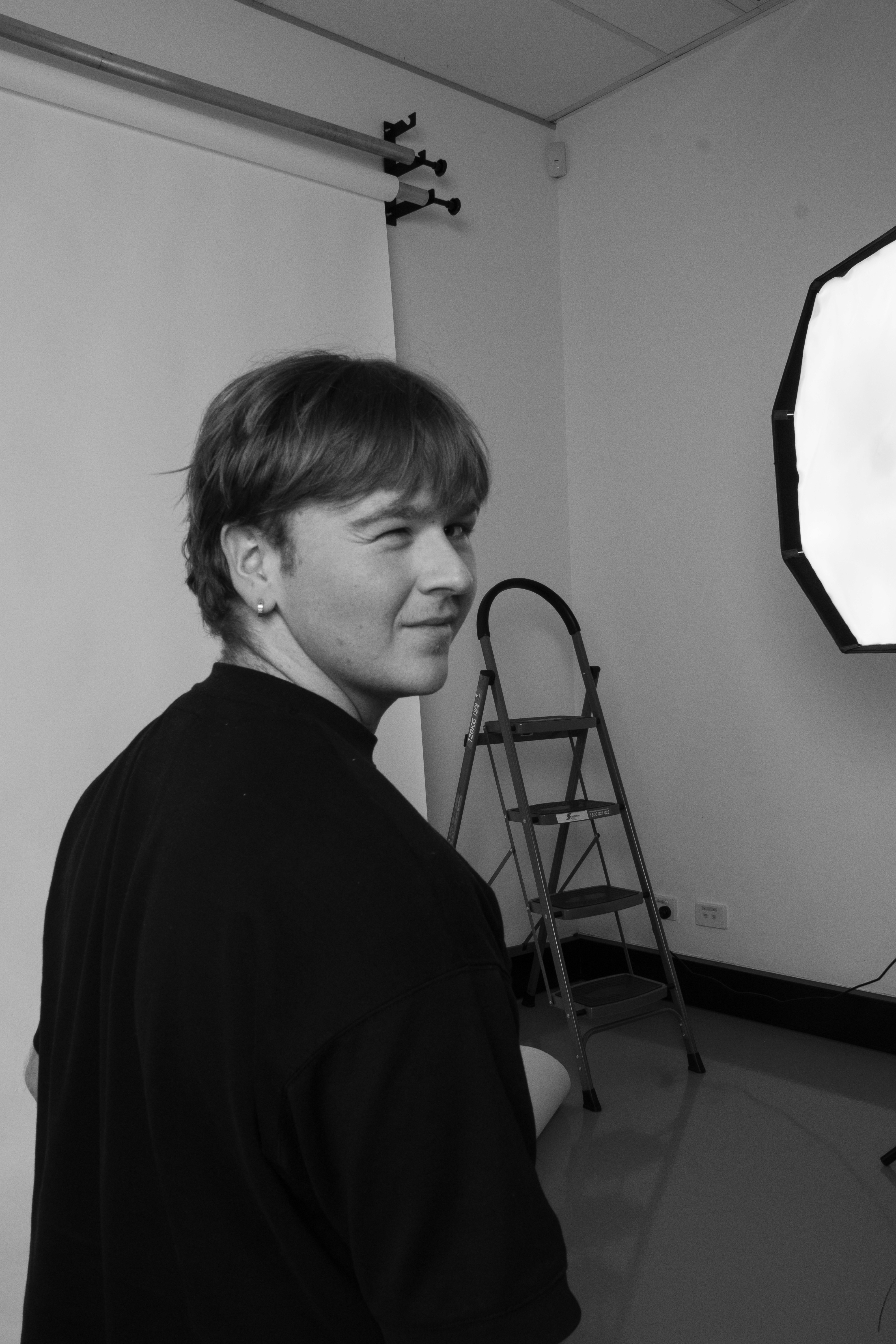 a blurry photo of a person standing in front of a wall