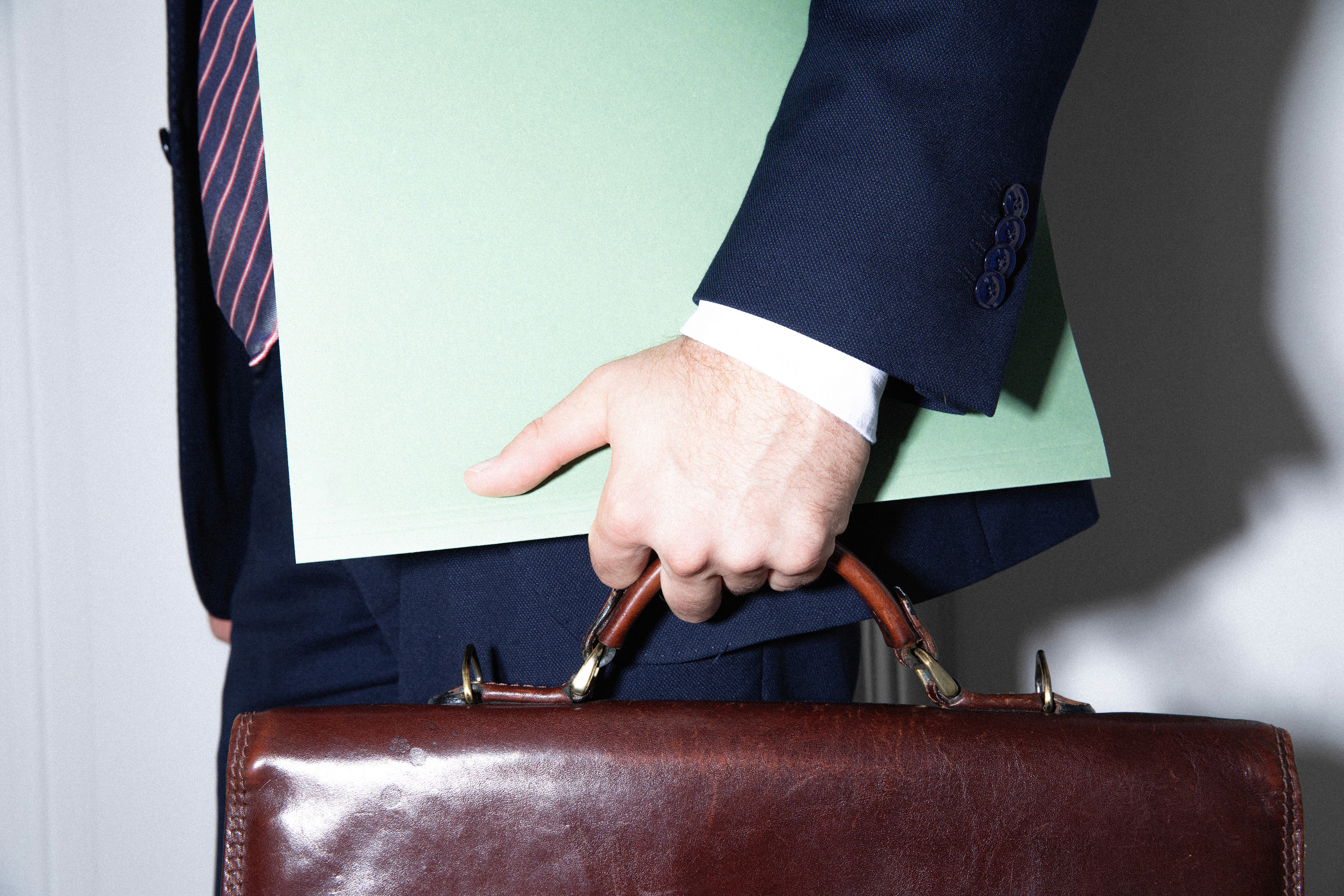 A black and white photo of a basketball casting a shadow on a plain background