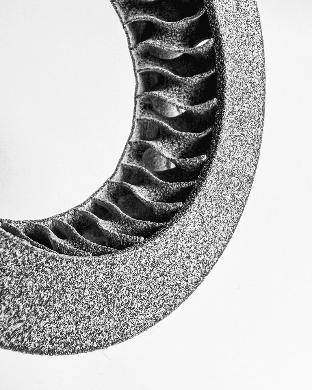 Zoomed in black and white detail of over the ear headphone cushion.