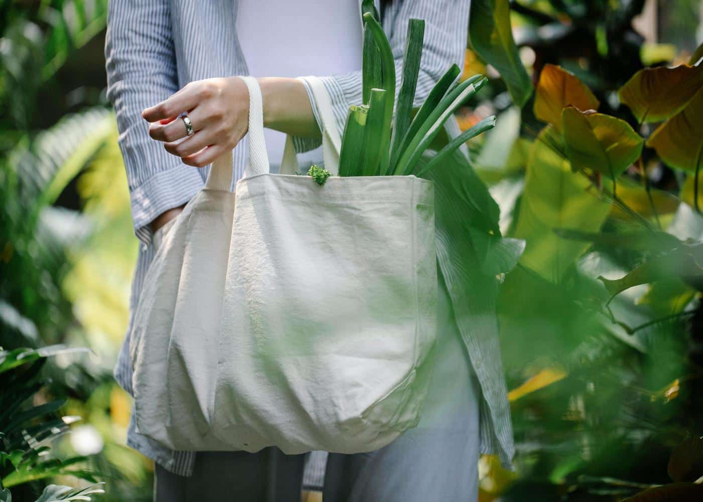 Woman with tote bag filled with plant-based food