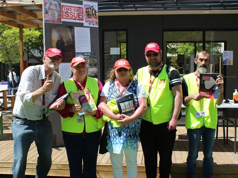 Big Issue vendors posing for a group photo