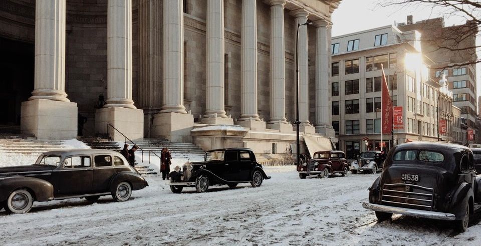 old cars in front of a national building with snow