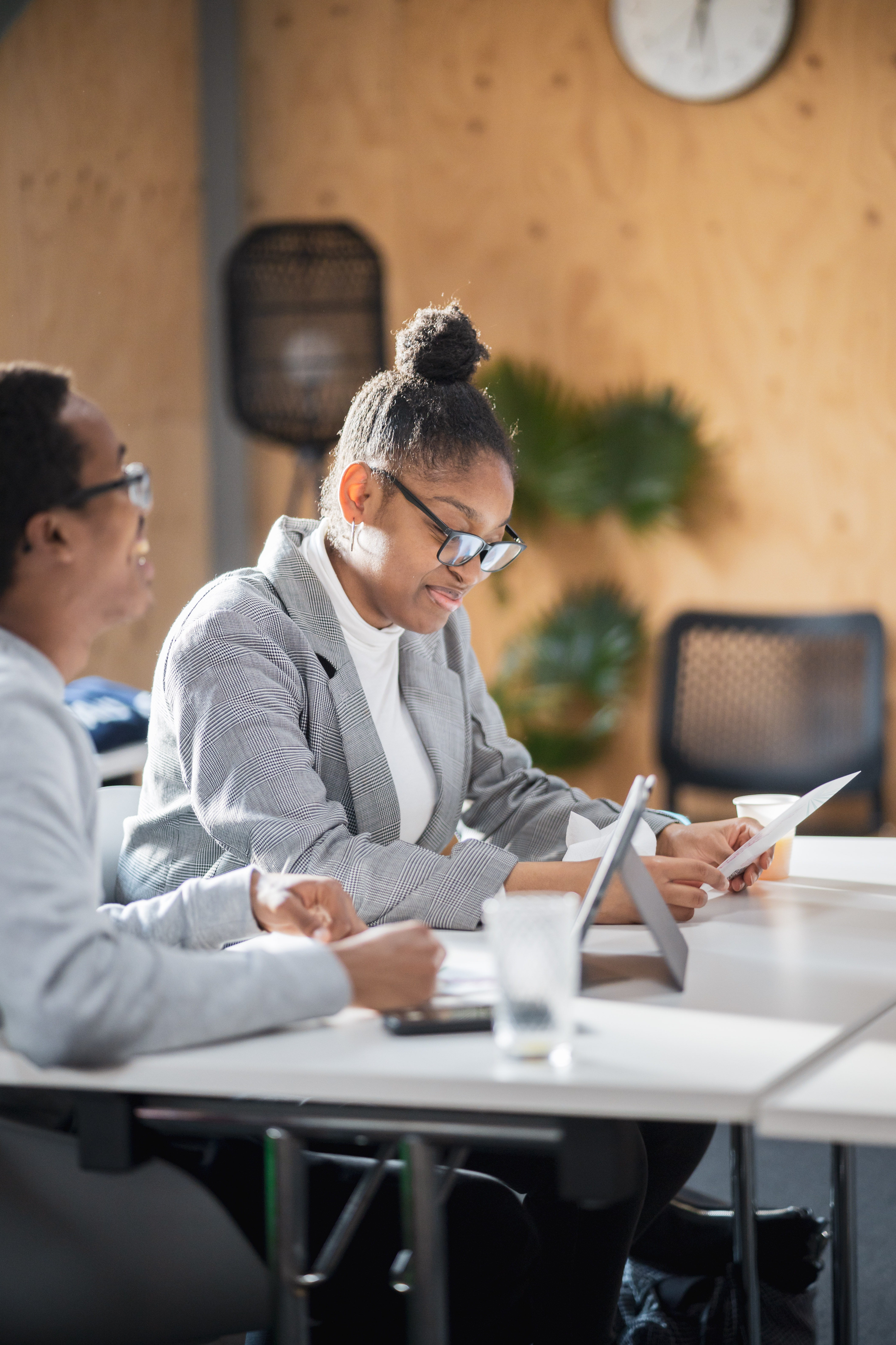 Diverse businesspeople in a meeting reviewing documents at a table.