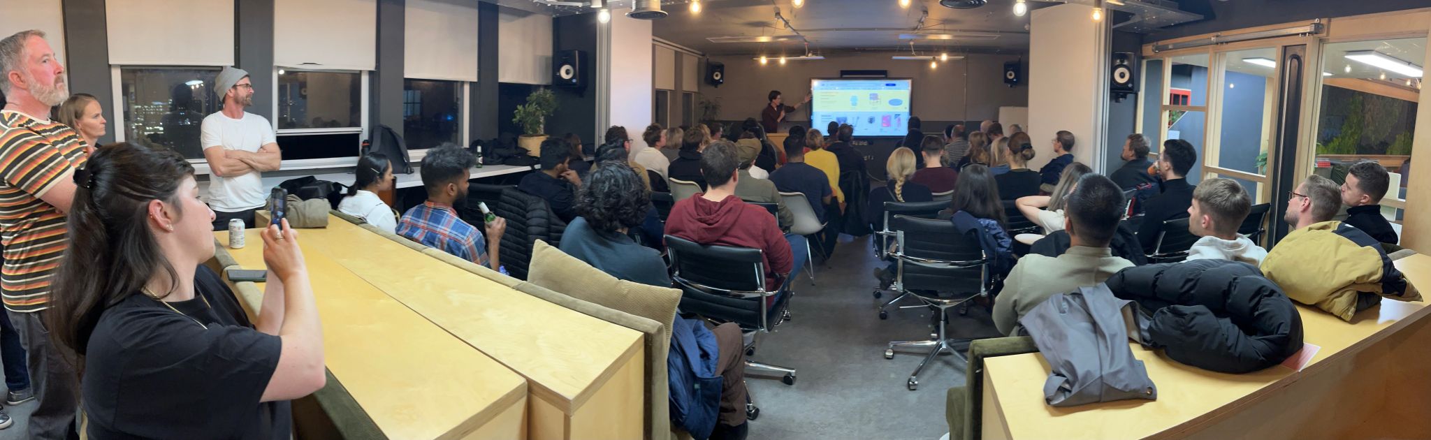Max presenting in front of a screen at UX Camp