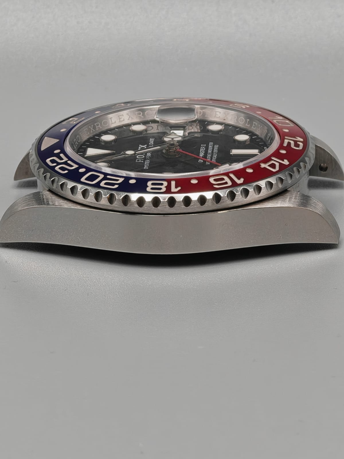 a close up of a watch on a black surface