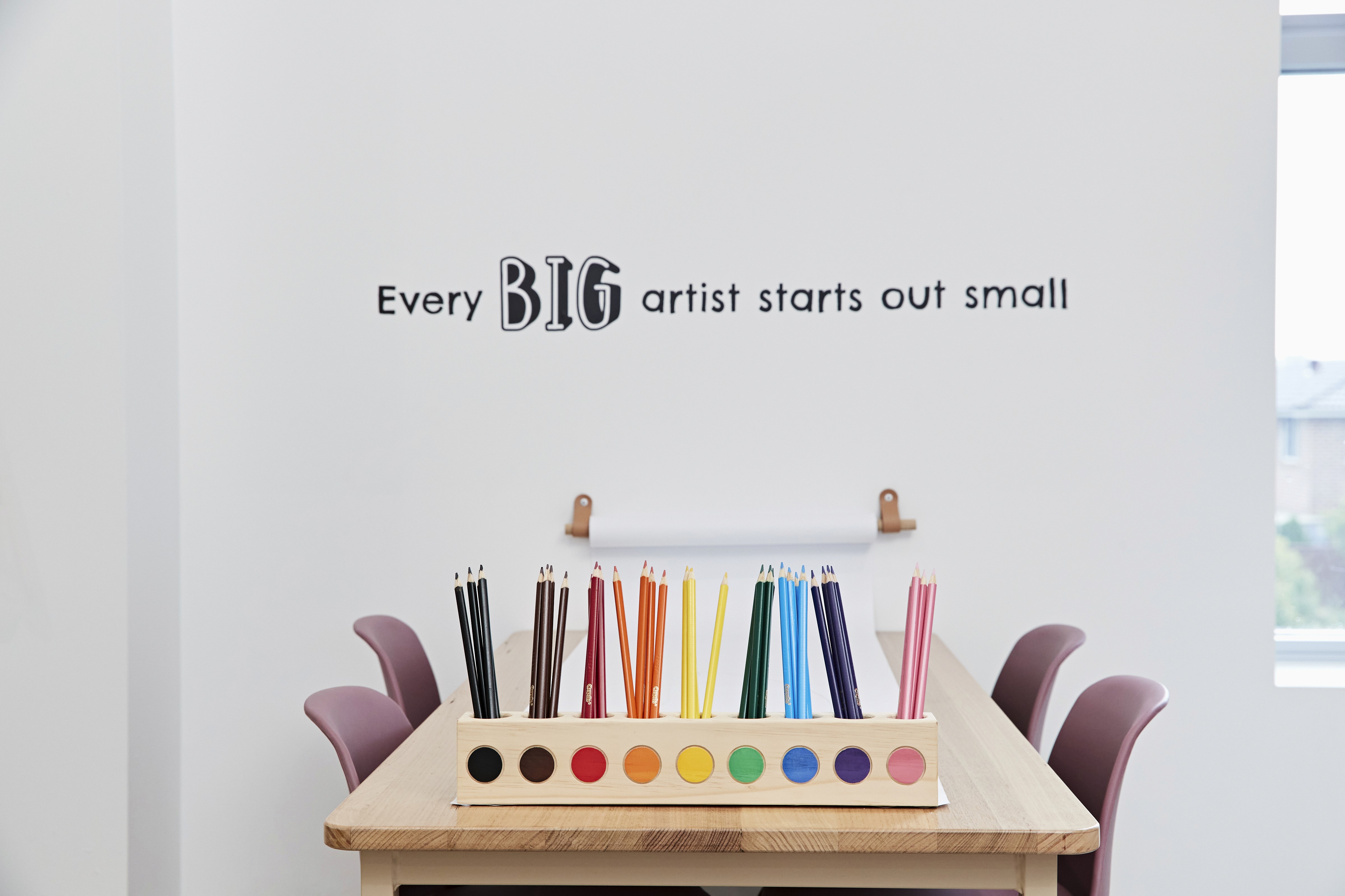 Close-up of a dark green leaf showing its textured surface and central vein against a muted background.