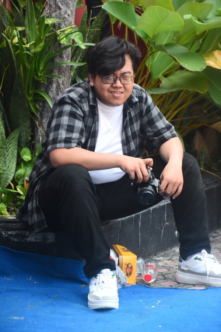 A young man riding a bicycle
