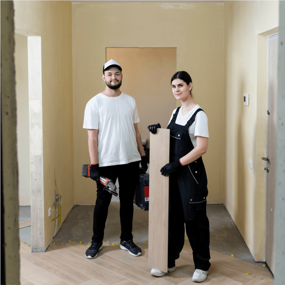 Team of two workers preparing a room for renovation.