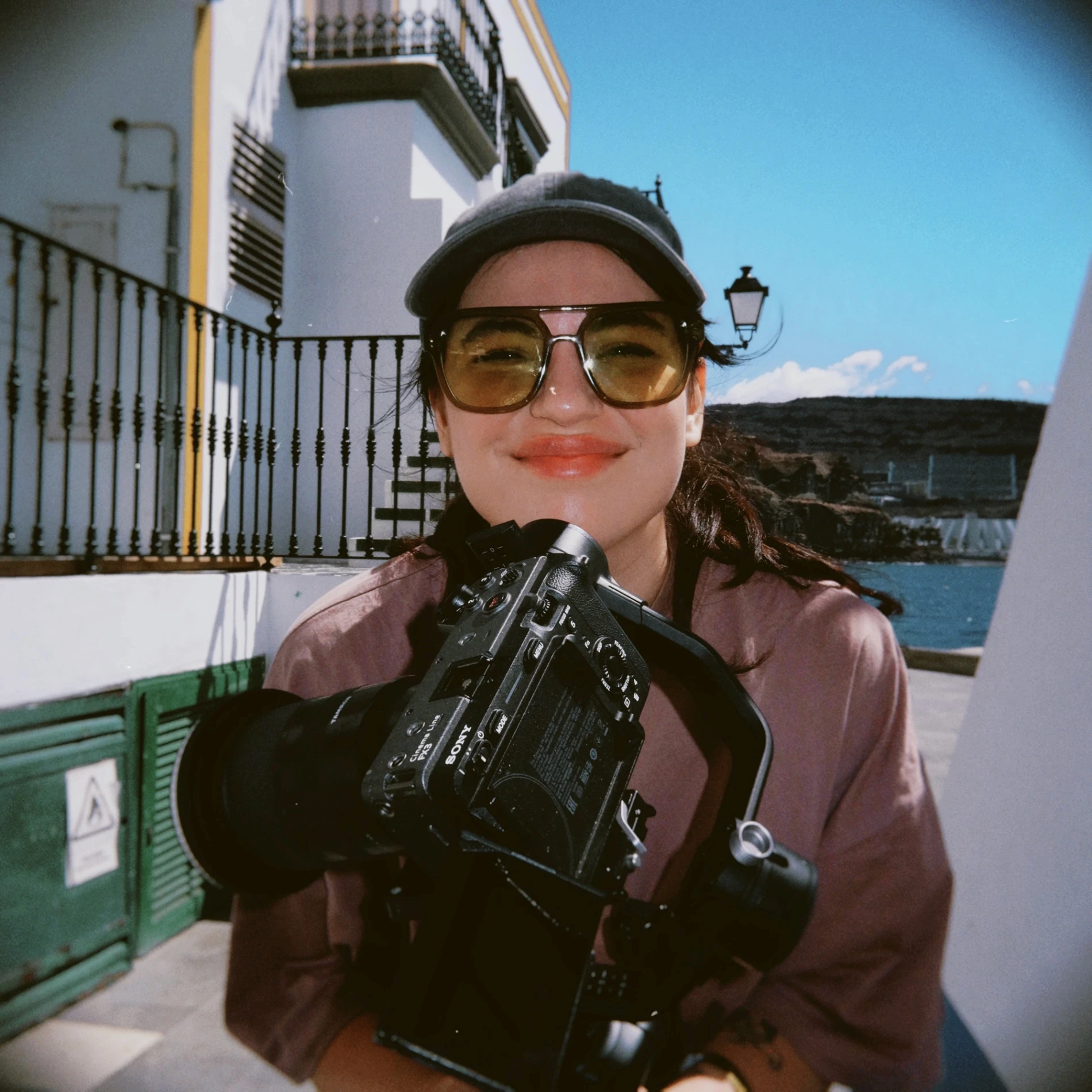 Three people sitting on a couch in a room looking at mobile devices