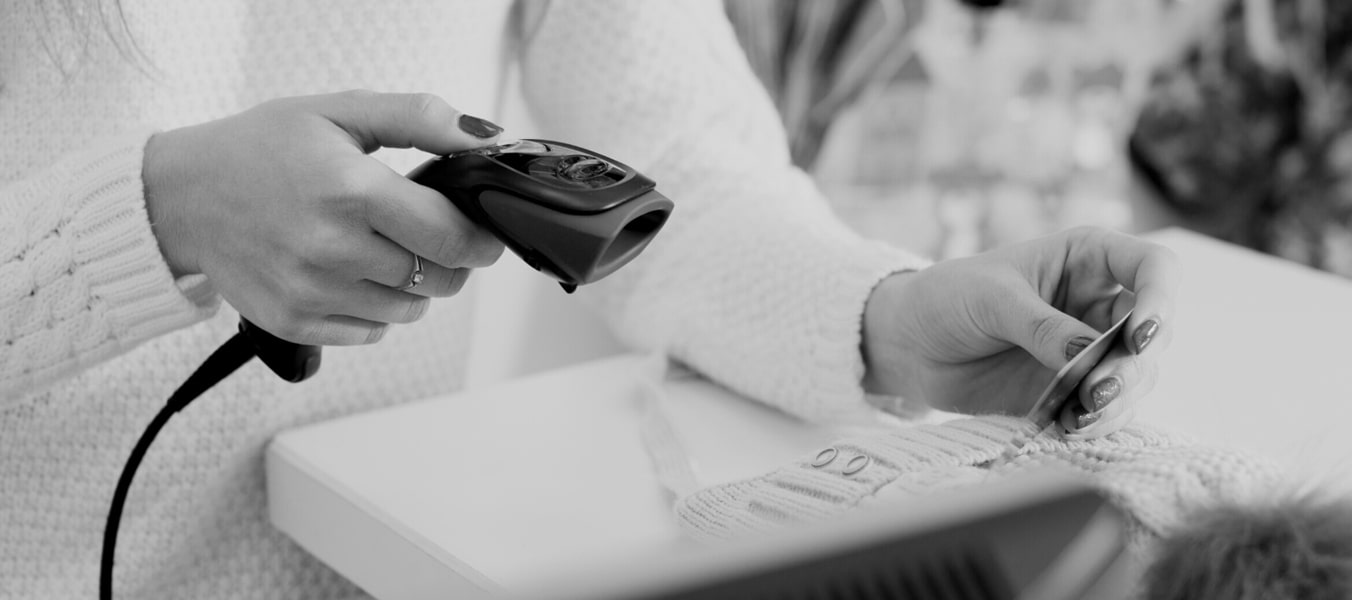 Laundromat employee scanning heat seal barcode
