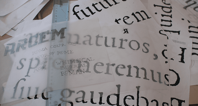 pile of typography papers and ruler on table