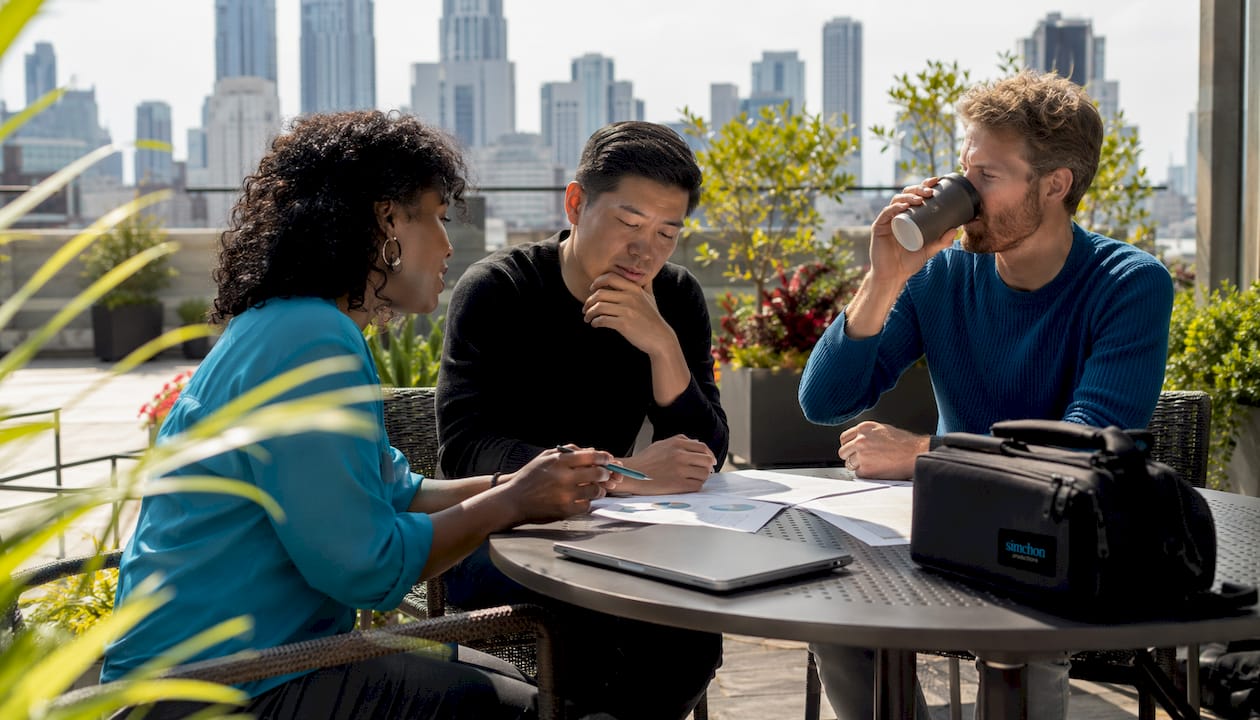 Team discussing video production alternatives around table