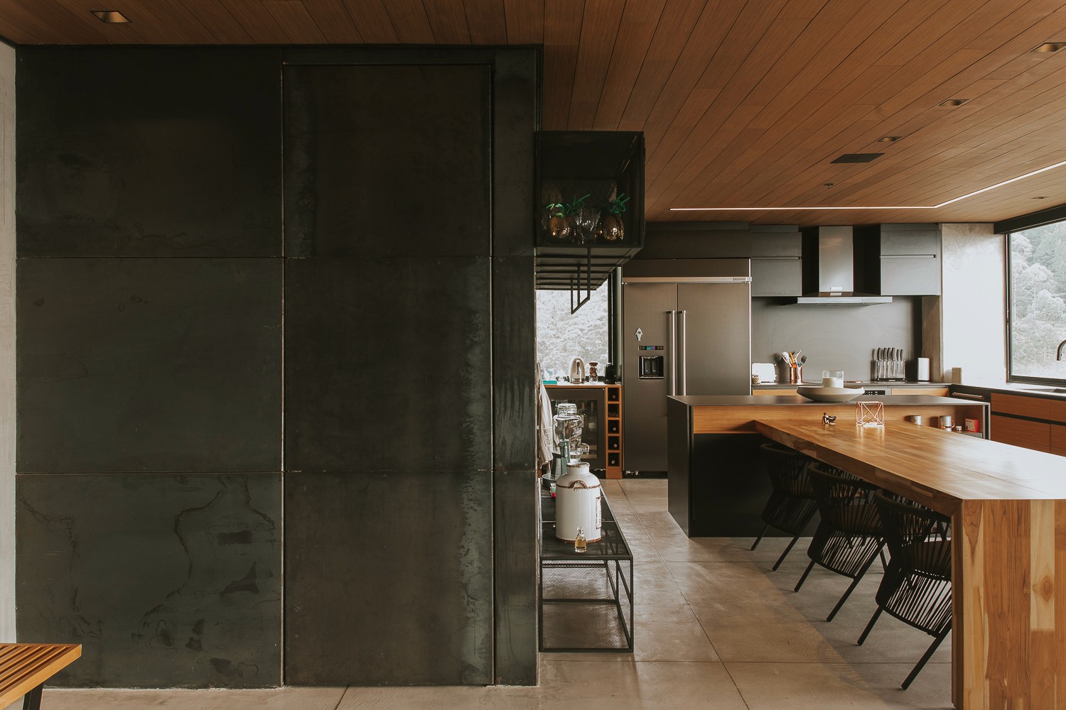 Double-height interior with flowing sculptural forms and warm raking light