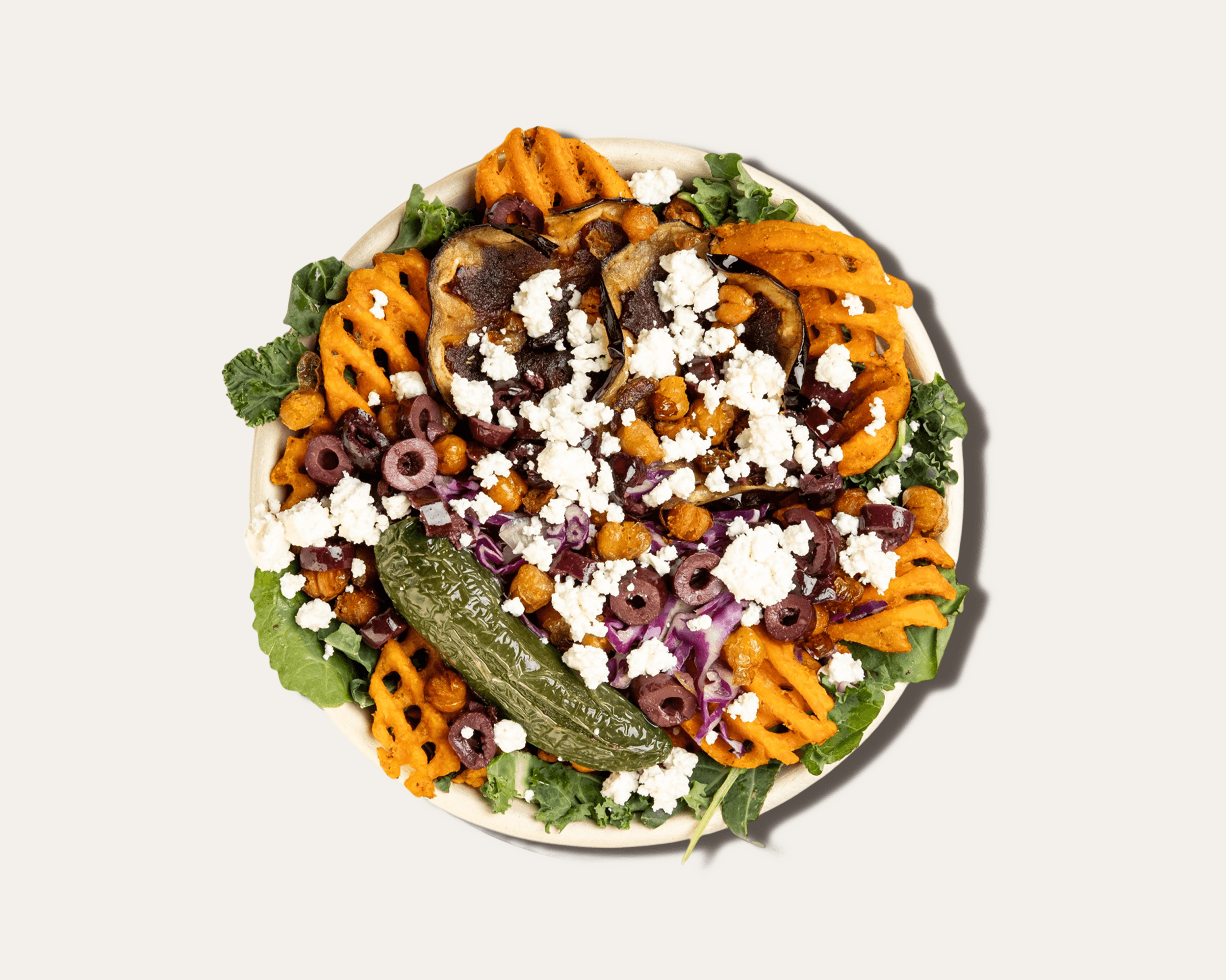 top down shot of a bowl of sweet potato fries with various toppings