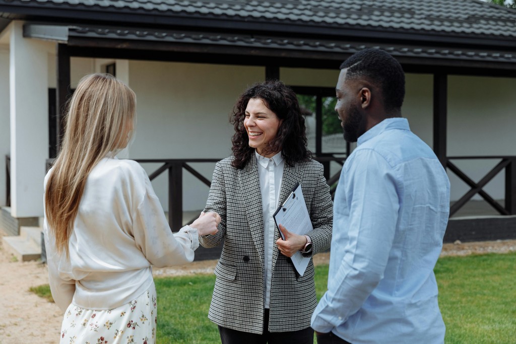 A couple shaking hands with a property agent