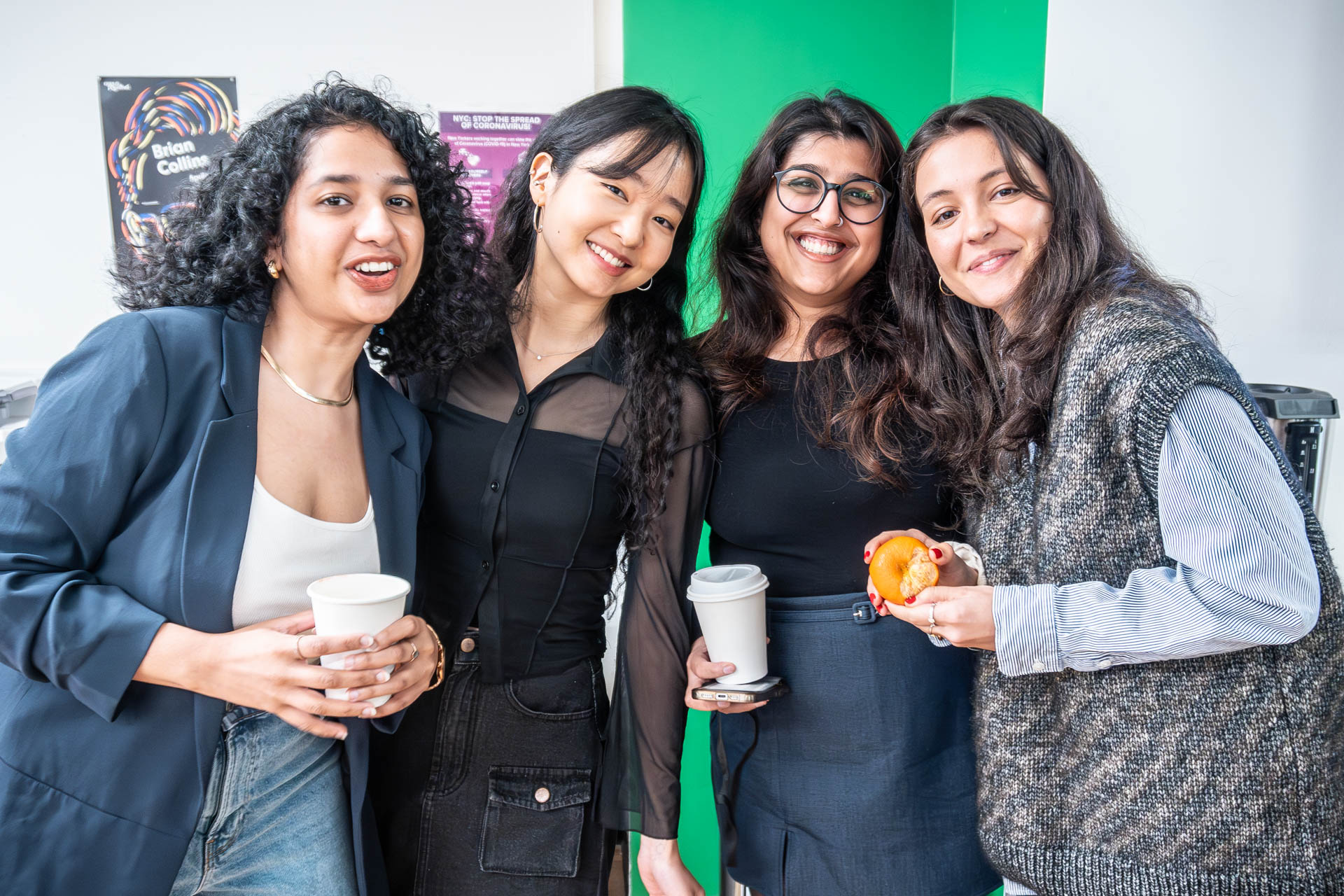 four students smiling and looking at the camera