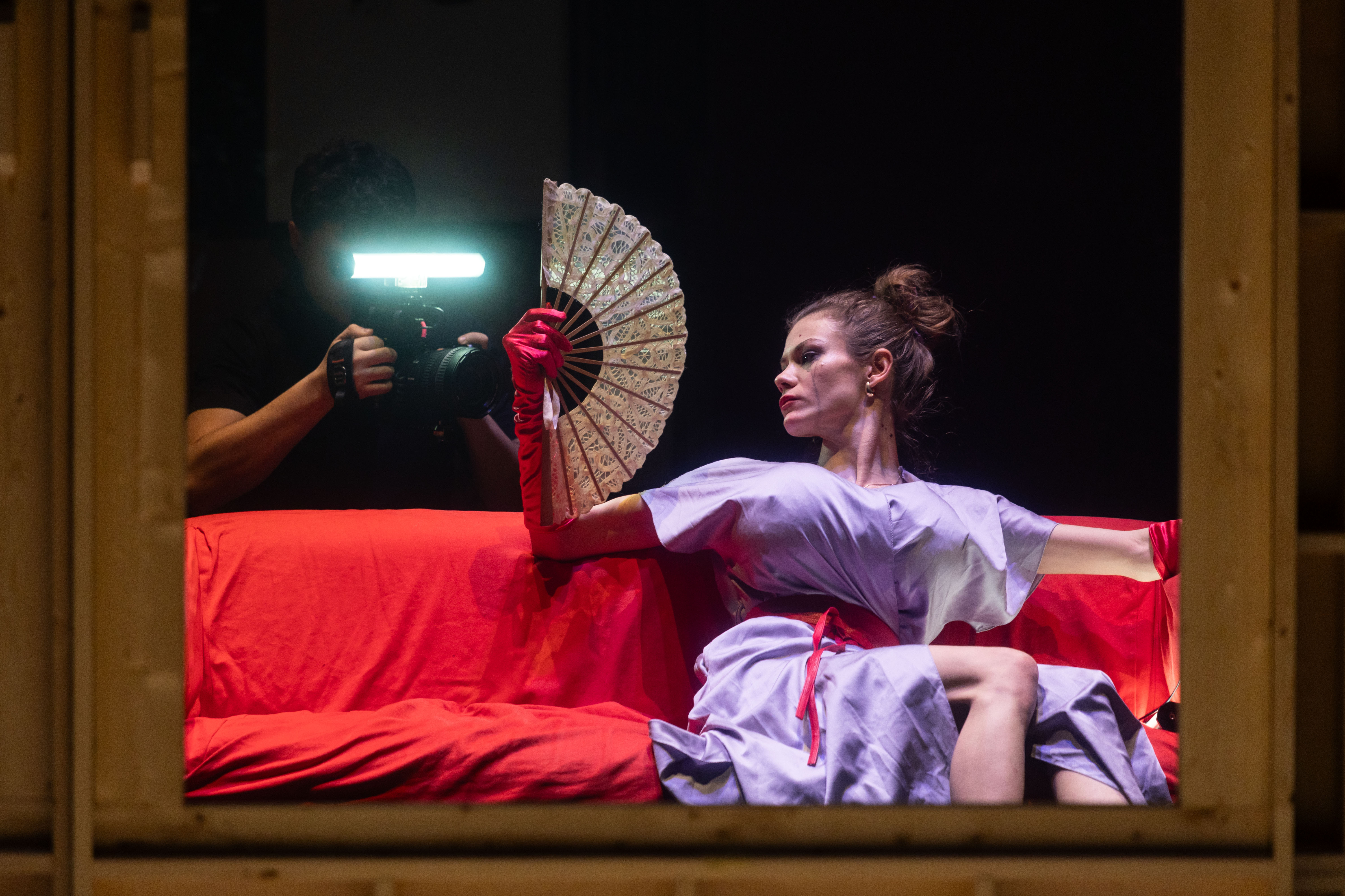 A person stands in a sandstone cave.