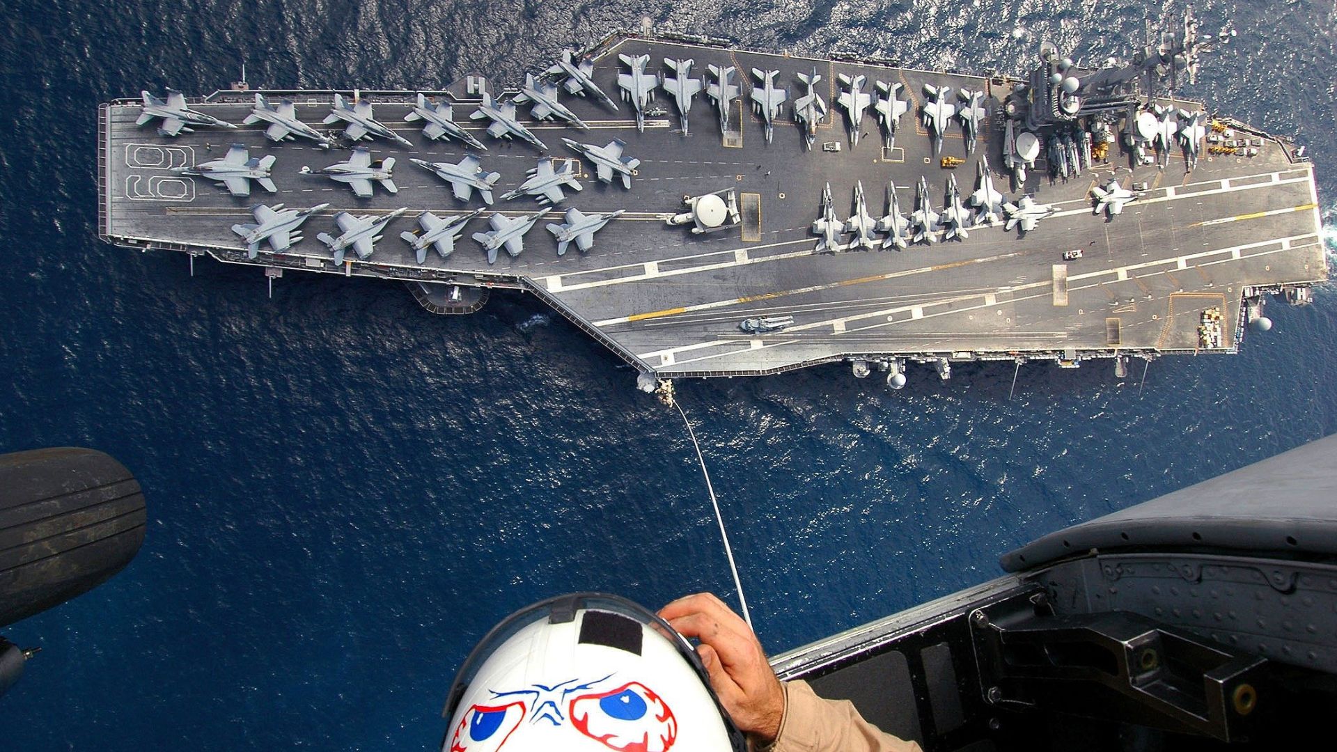 aerial view of navy ship with military jets