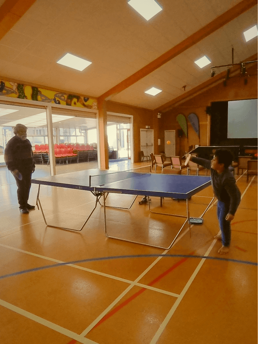 Two generations playing table tennis