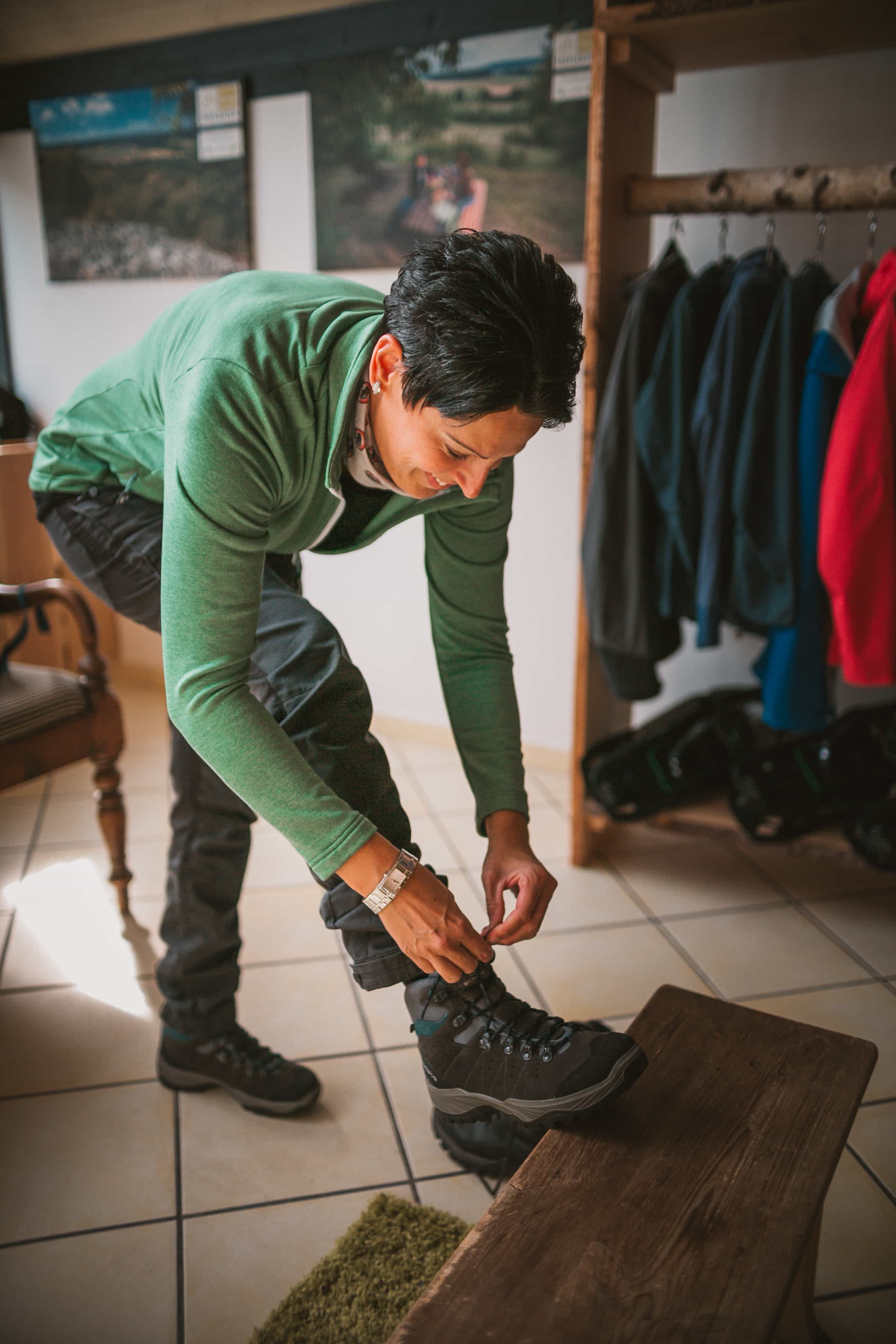 Woman ties her shoes